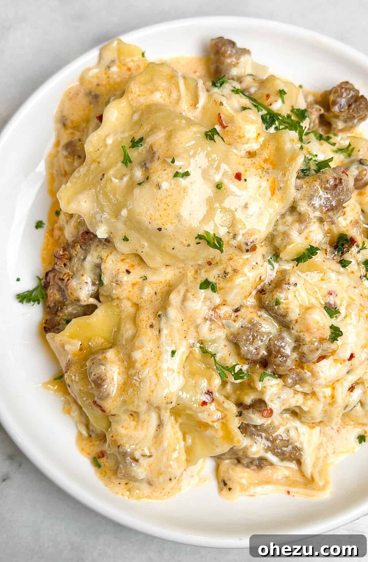 A freshly baked Alfredo Ravioli Lasagna, golden brown and bubbling, ready to be served.