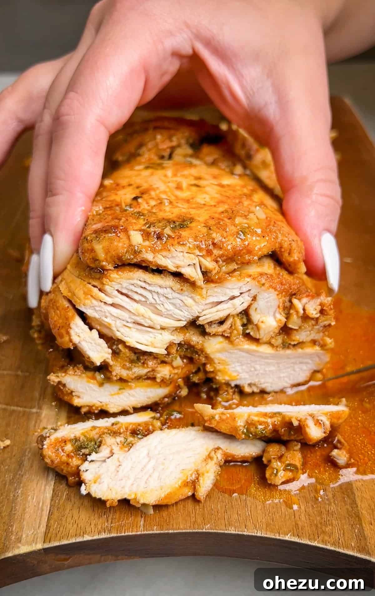 Oven-baked chicken shawarma stacked in a loaf pan, ready for cooking