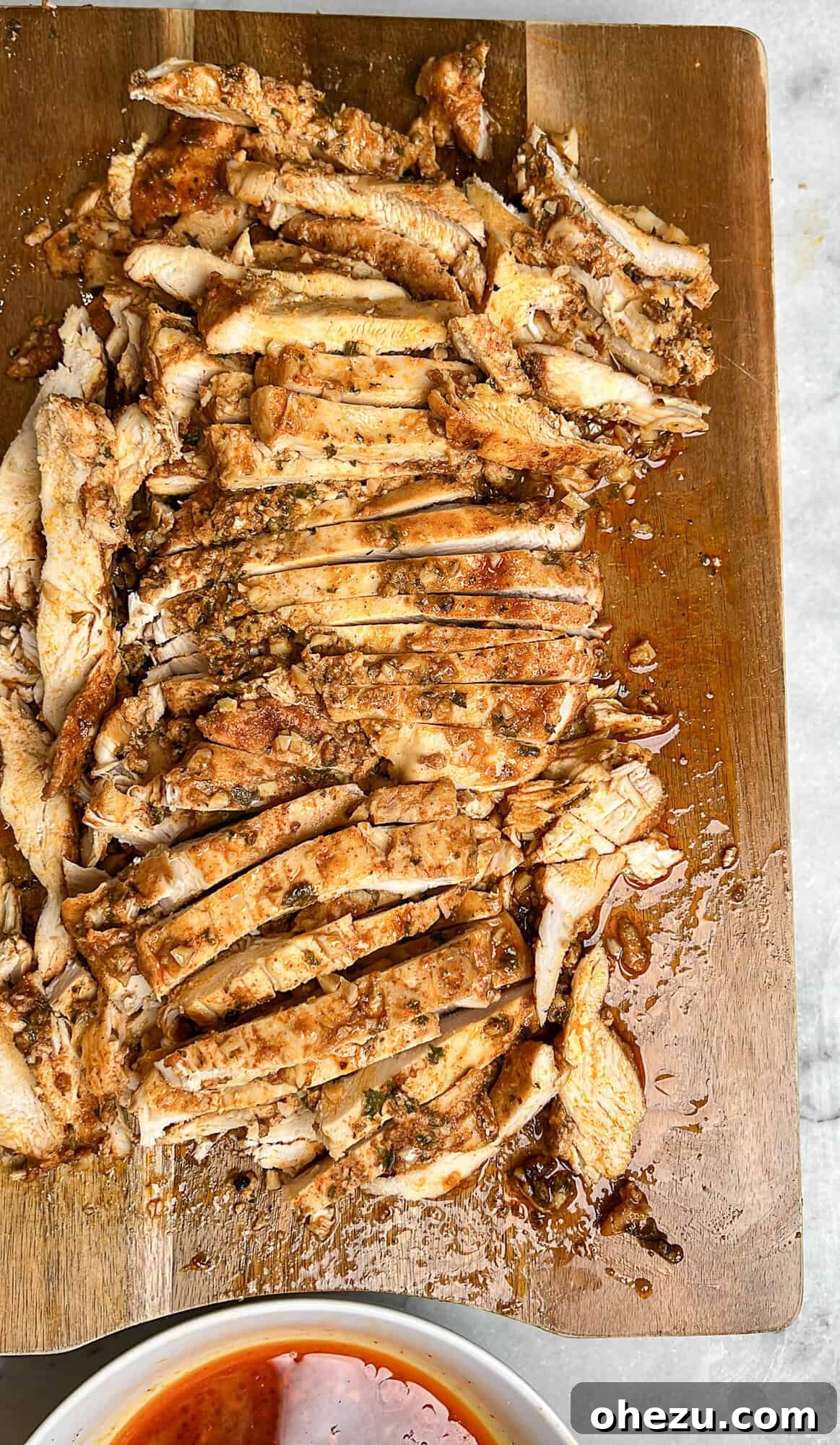 Close-up of marinated chicken pieces before baking for shawarma