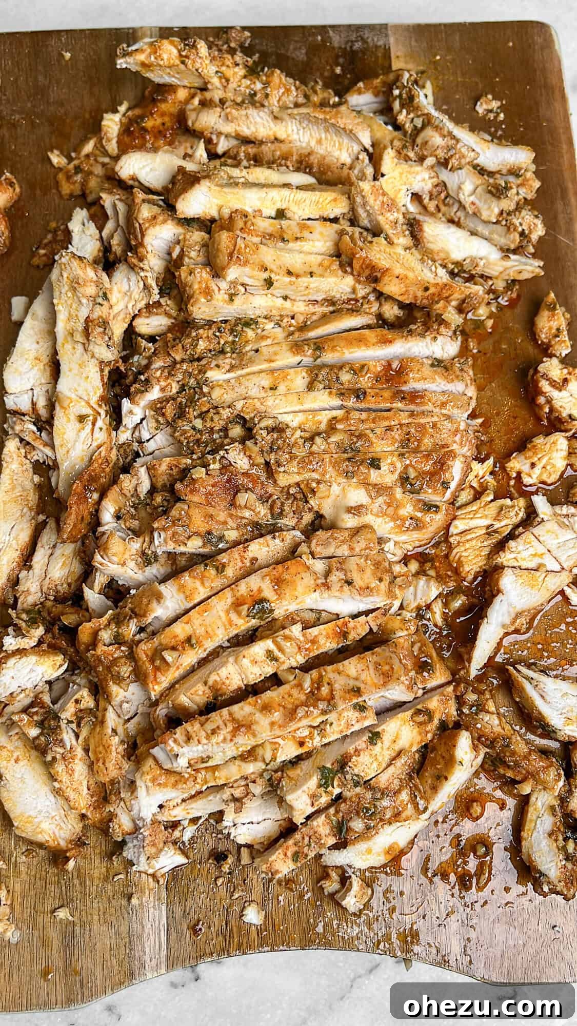 Thinly sliced chicken shawarma on a cutting board, ready to serve