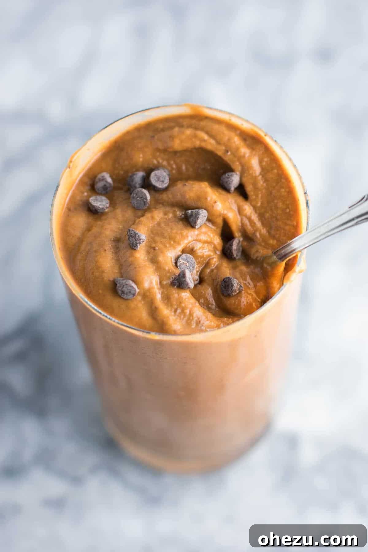 25 Must-Try Vegan Recipes for Plant-Based Perfection 23 A tall glass of healthy double chocolate milkshake, thick and rich, topped with chocolate shavings.