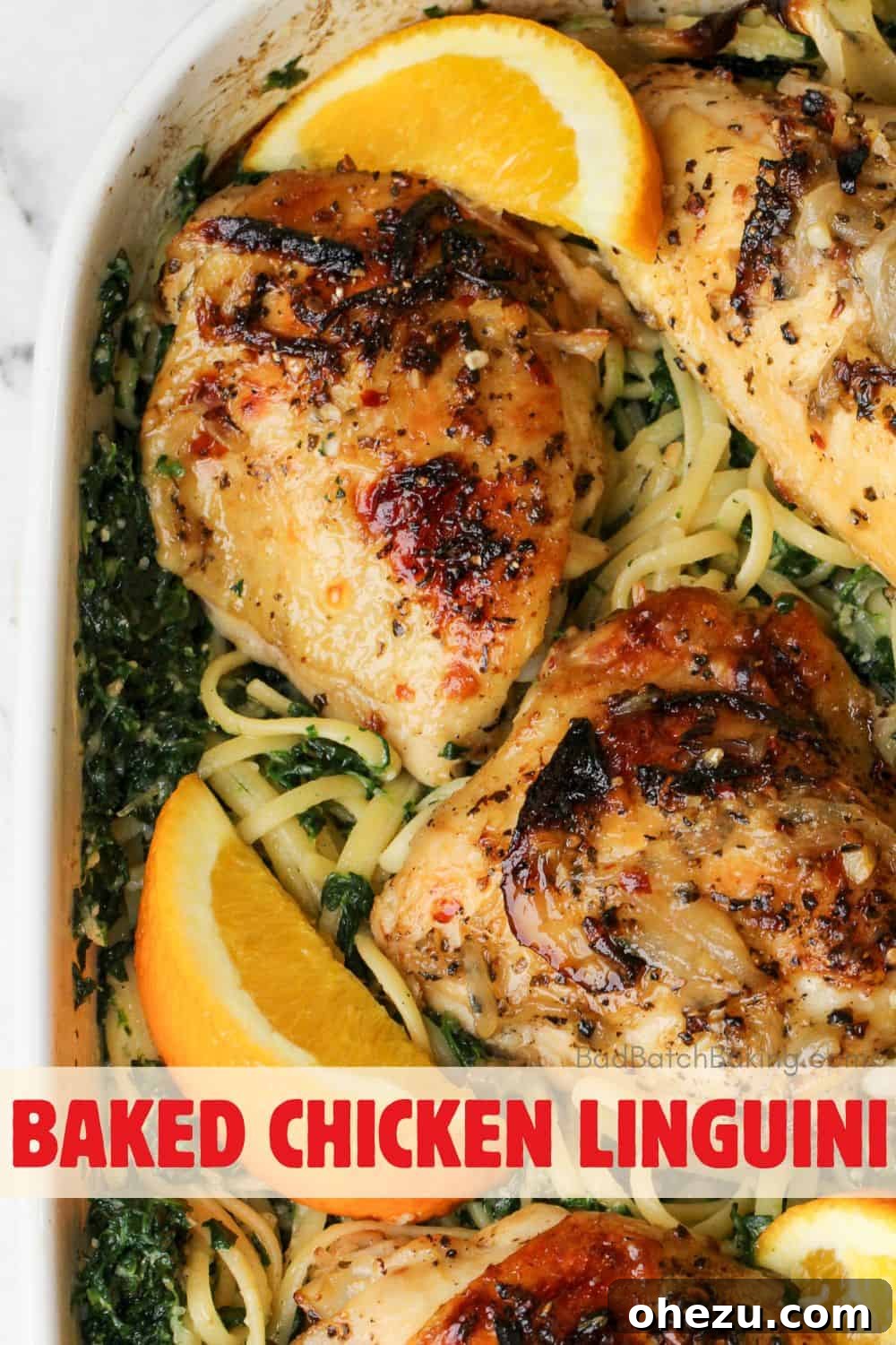 A delicious plate of oven baked chicken linguini, garnished with fresh spinach and orange