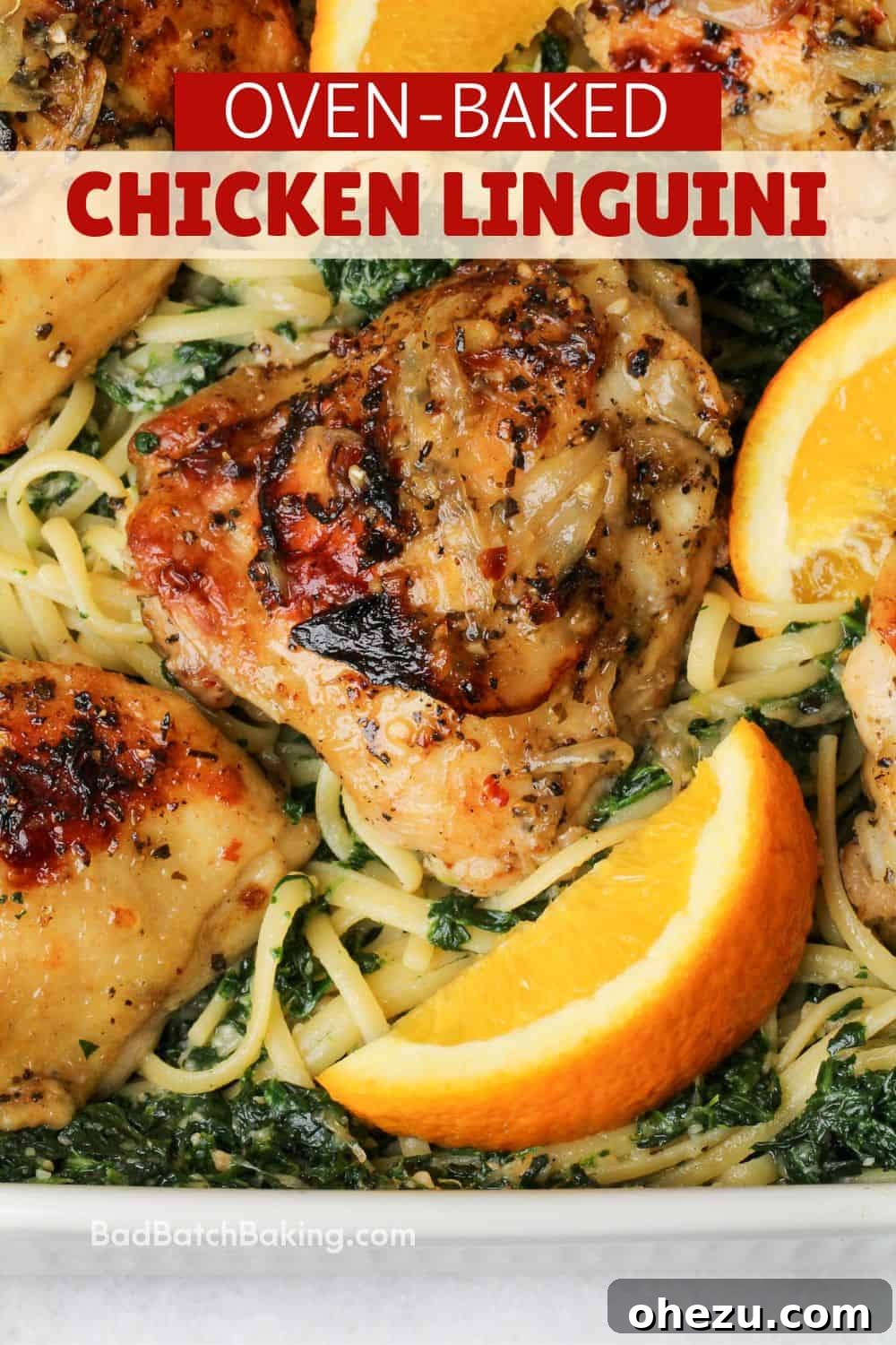 A vibrant plate of chicken linguini with spinach and fresh orange wedges