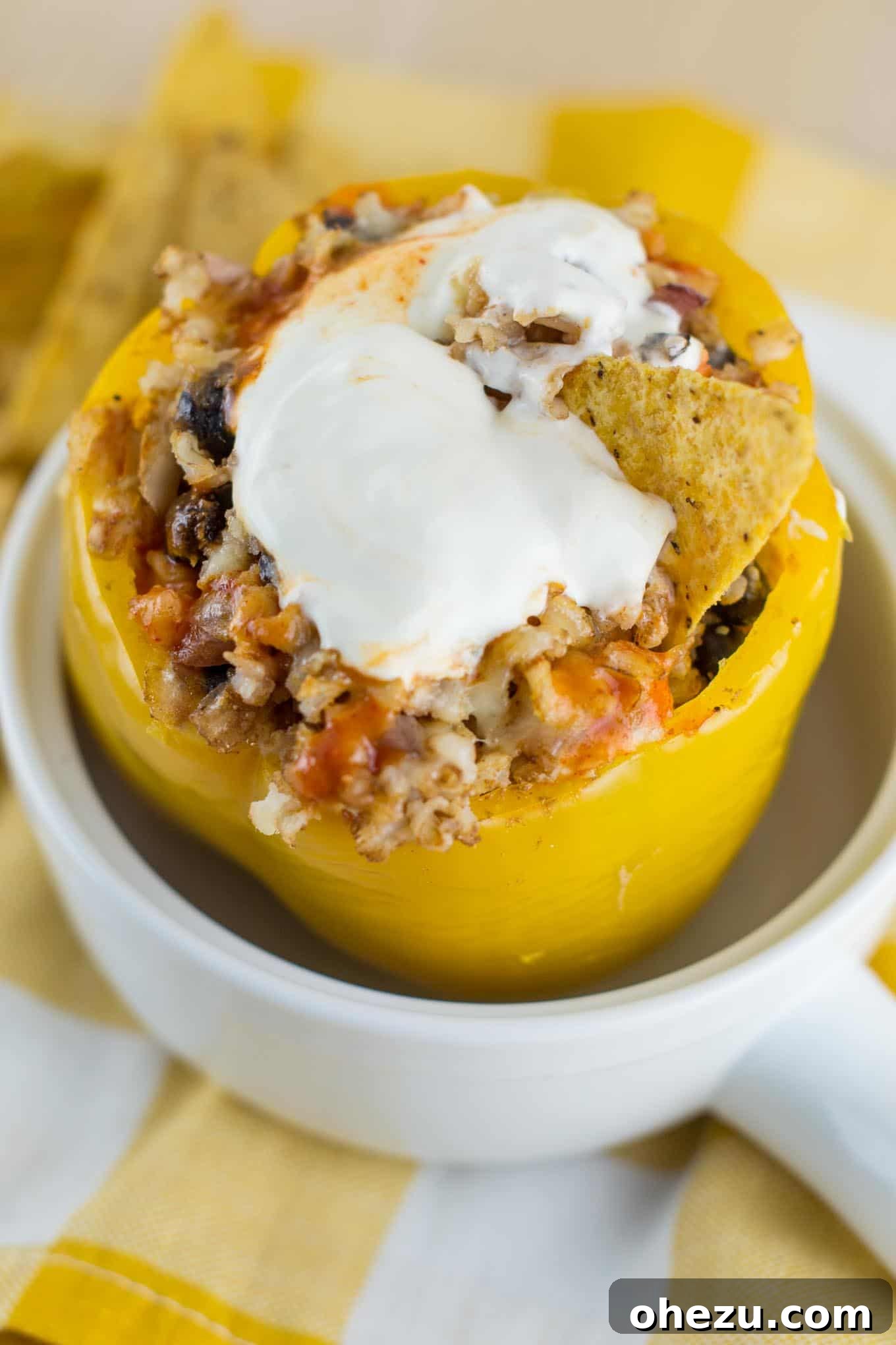 No-Fuss Slow Cooker Plant-Based Stuffed Peppers 9 Close-up of a beautifully cooked vegetarian crockpot stuffed pepper, garnished and ready to eat.
