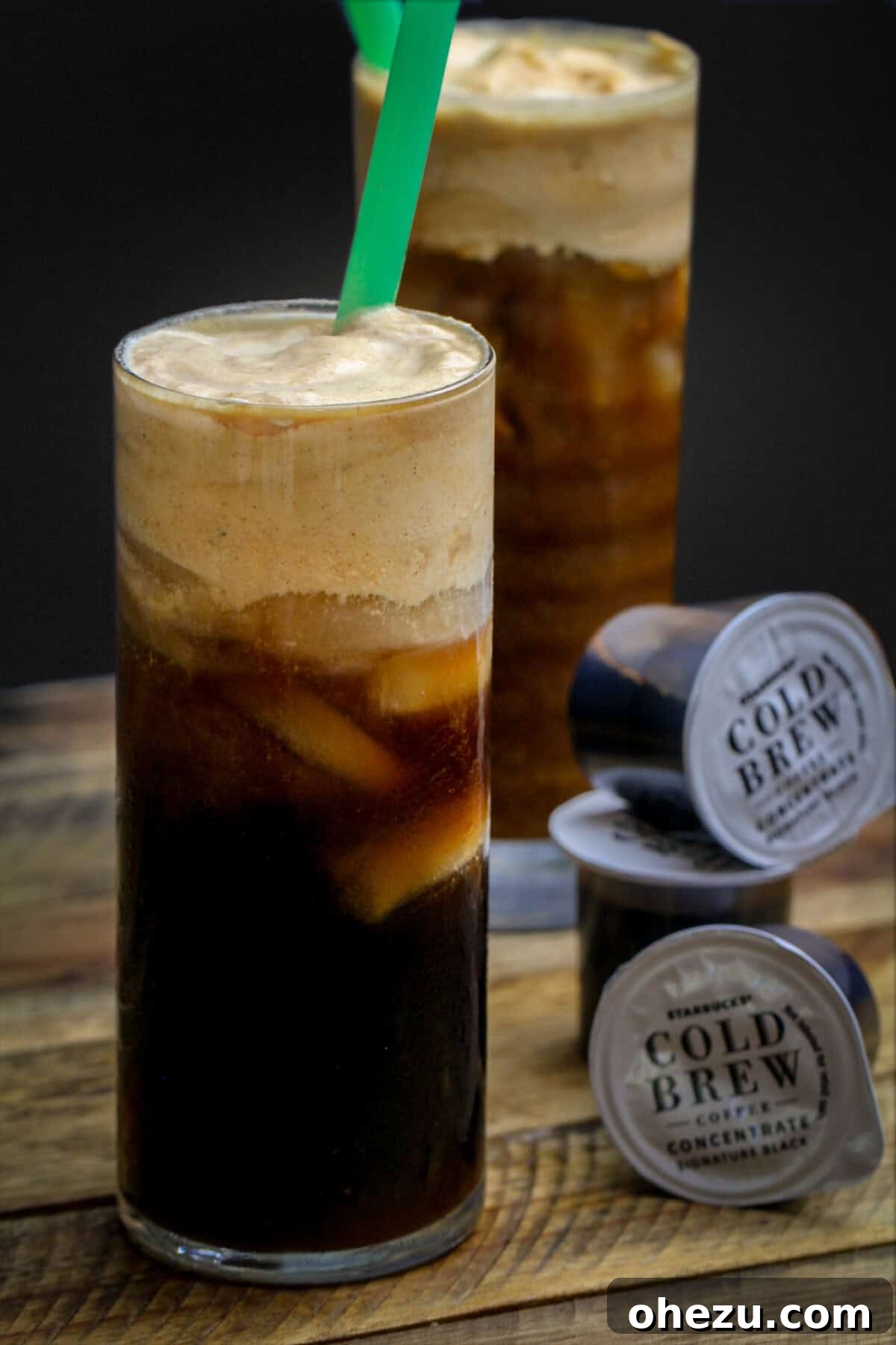A tall glass of The Best Starbucks Pumpkin Cream Cold Brew Copycat Recipe, topped with frothy pumpkin cream.