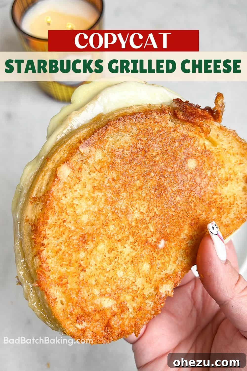 A freshly made copycat Starbucks grilled cheese sandwich resting on a cutting board, ready to be sliced and served.