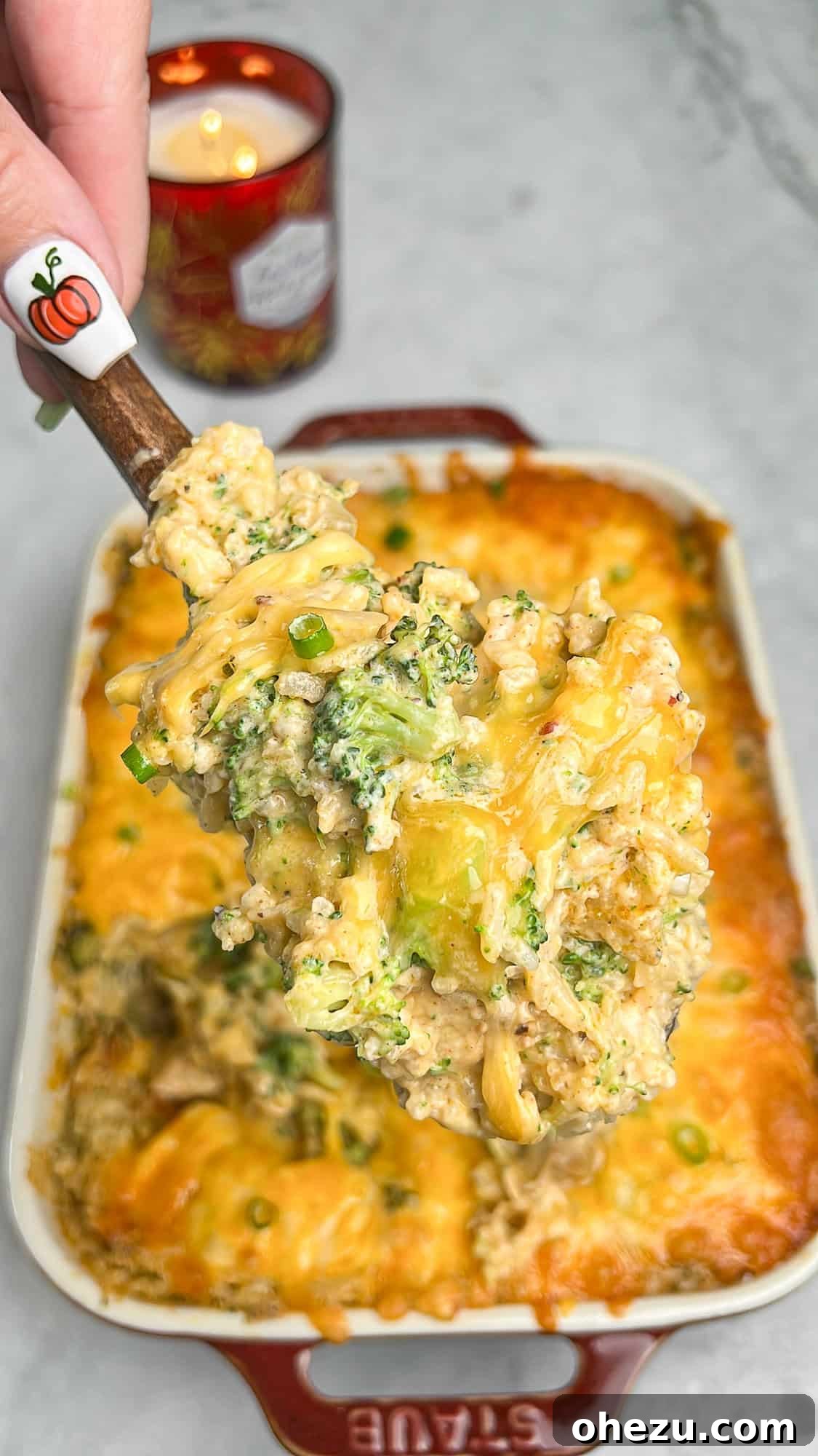Golden Cheesy Chicken Broccoli Rice Bake 4 A baking dish filled with unbaked broccoli rice casserole, showing layers of ingredients