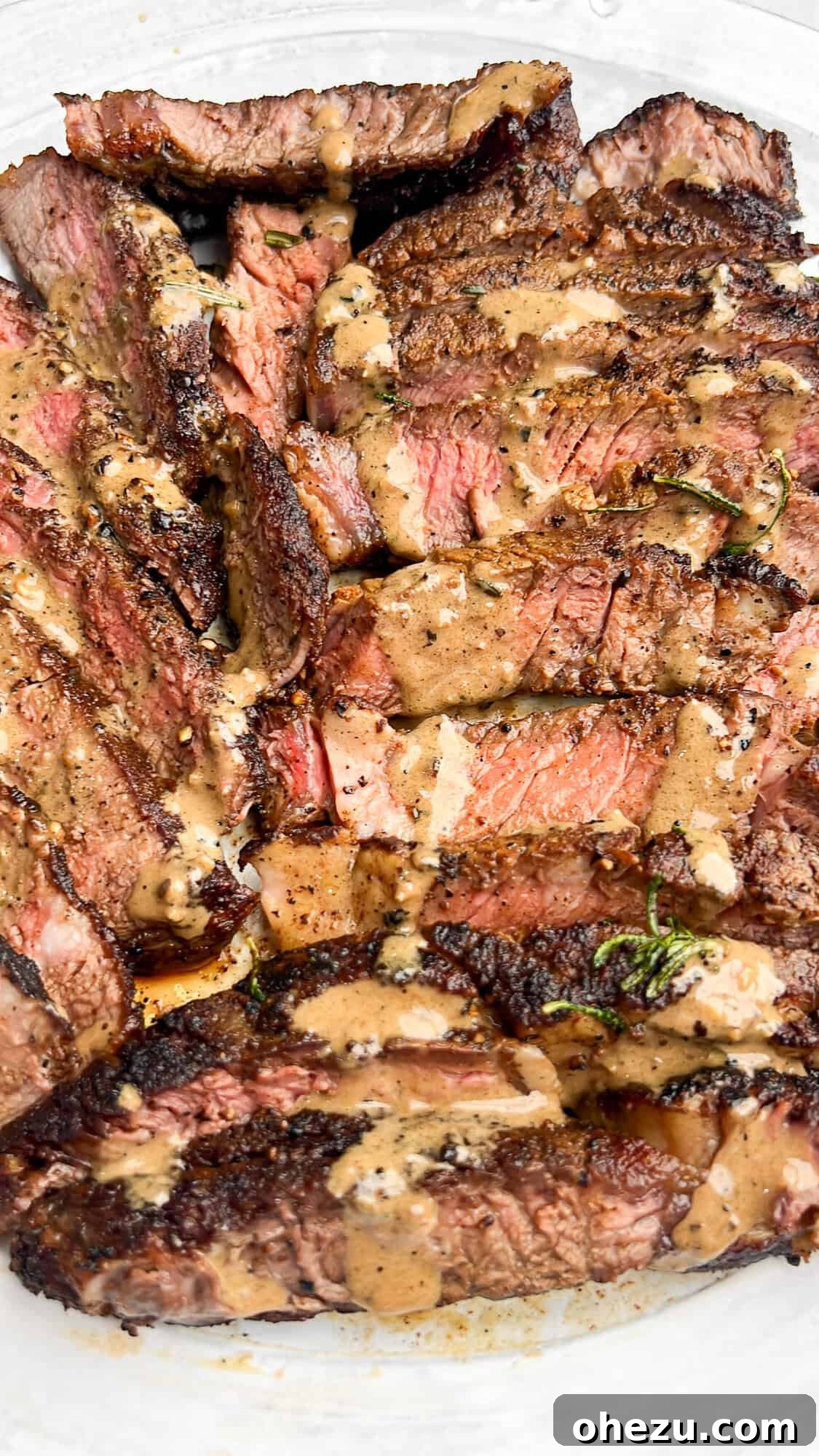 Cognac Kissed Cast Iron Steak 6 Perfectly cooked steak sliced and served with cognac peppercorn sauce.