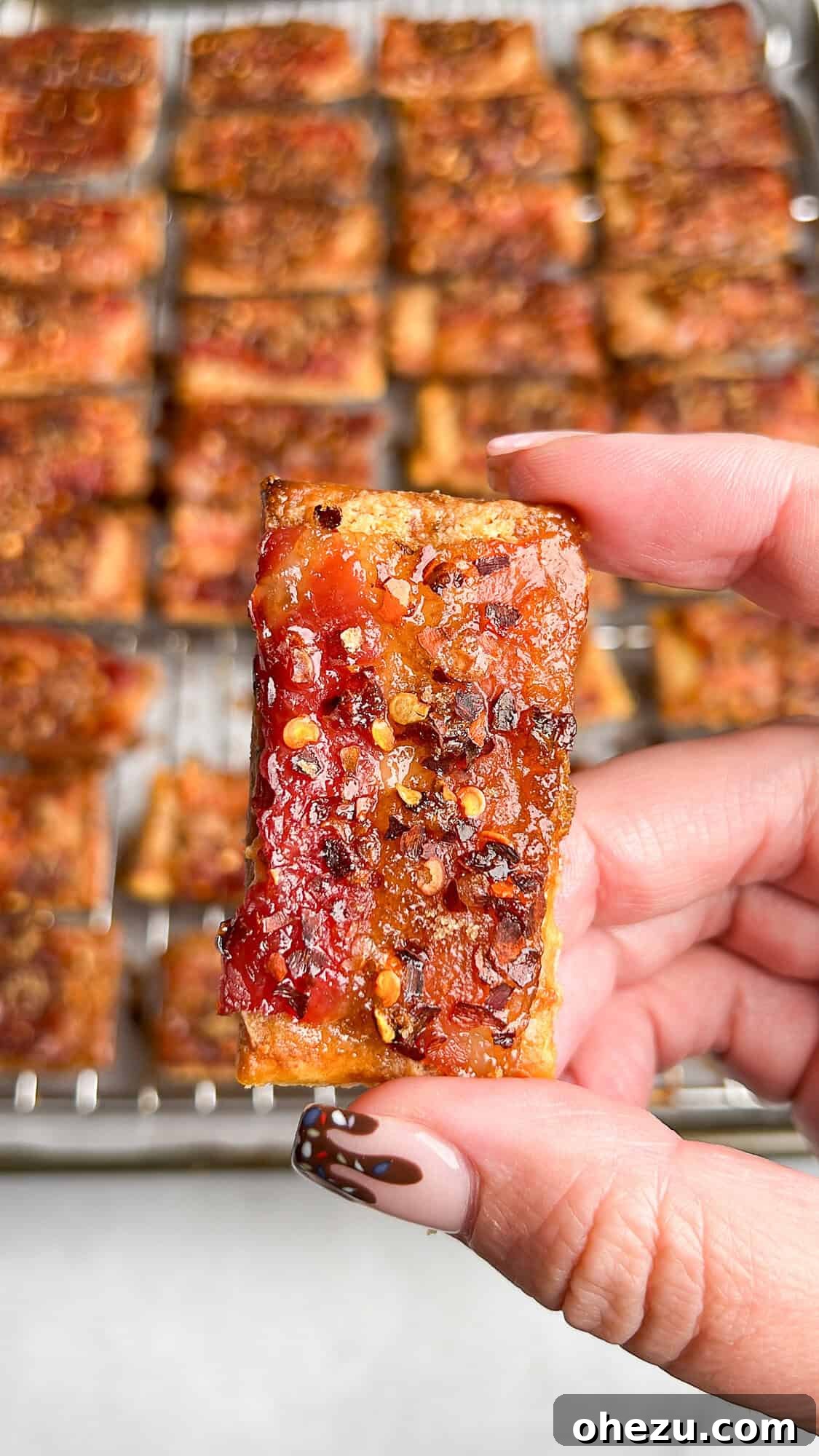 Delicious Boursin Candied Bacon Crackers arranged on a serving platter, showcasing their golden crispness and savory toppings.