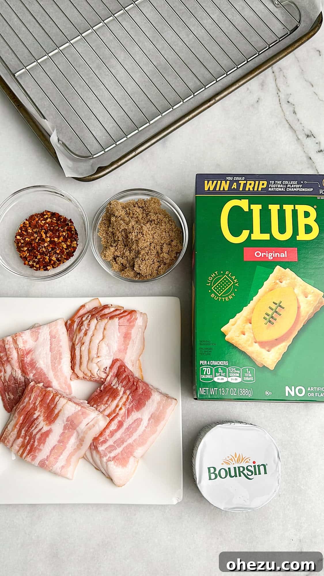 The five key ingredients for Boursin Candied Bacon Crackers laid out: Club crackers, bacon, Boursin cheese, brown sugar, and red pepper flakes.