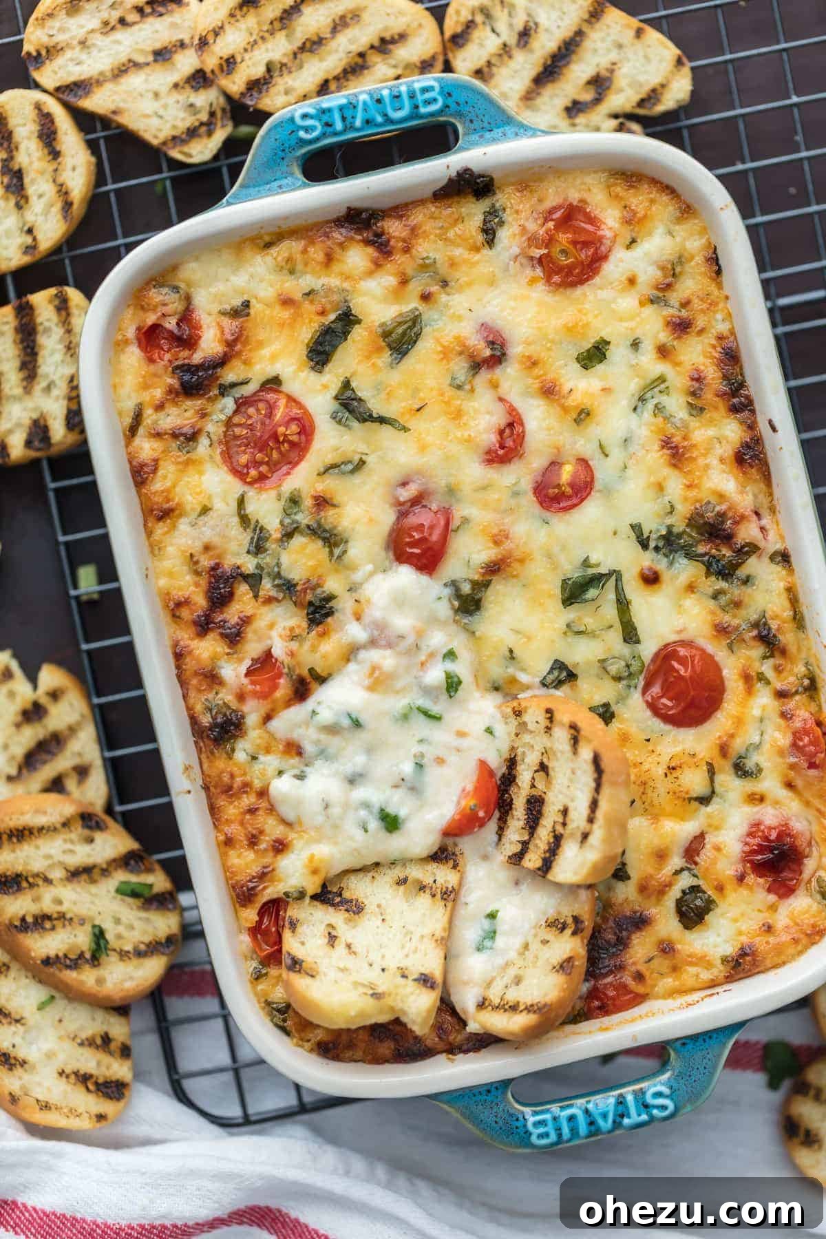 Over 70 Perfect Friendsgiving Recipes to Try in 2024 13 Festive Cheesy Tomato Caprese Dip for Holiday Parties