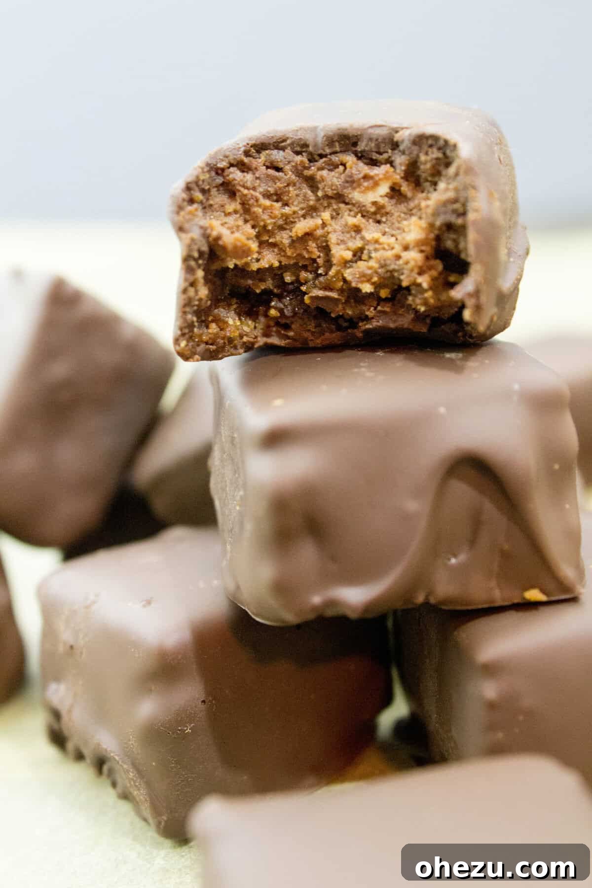 A vibrant display of freshly prepared Triple Chocolate Dipped Cheesecake Bites on a white platter, ready to be enjoyed.