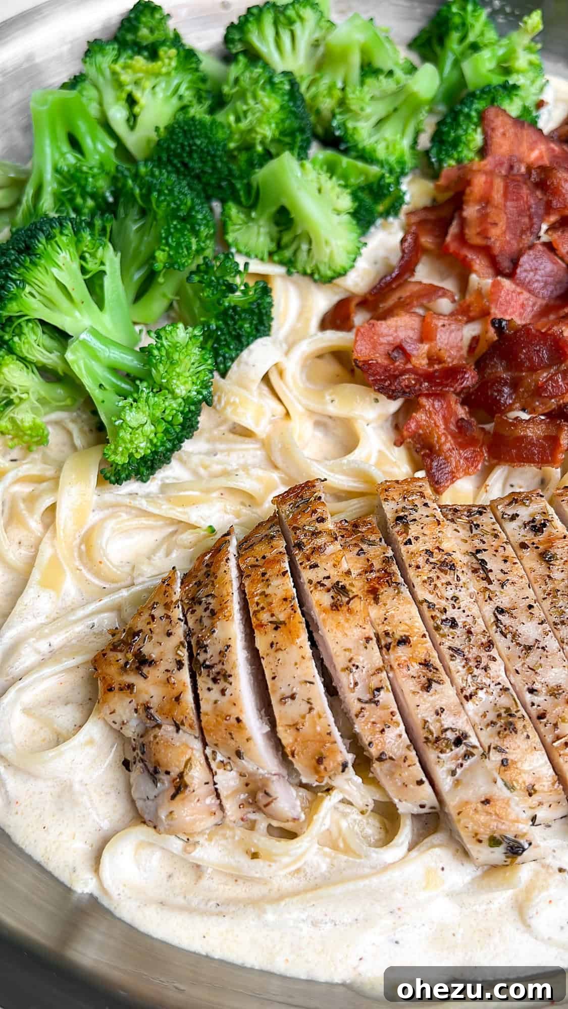 Golden Chicken & Crispy Bacon Broccoli Alfredo 7 Chicken fettuccini alfredo in a bowl with fork