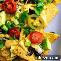 Ultimate Loaded Vegetable Nachos 10 Loaded veggie nachos topped with homemade nacho cheese sauce. These are amazing! #veggienachos #vegetarian #nachocheese #nachocheesesauce