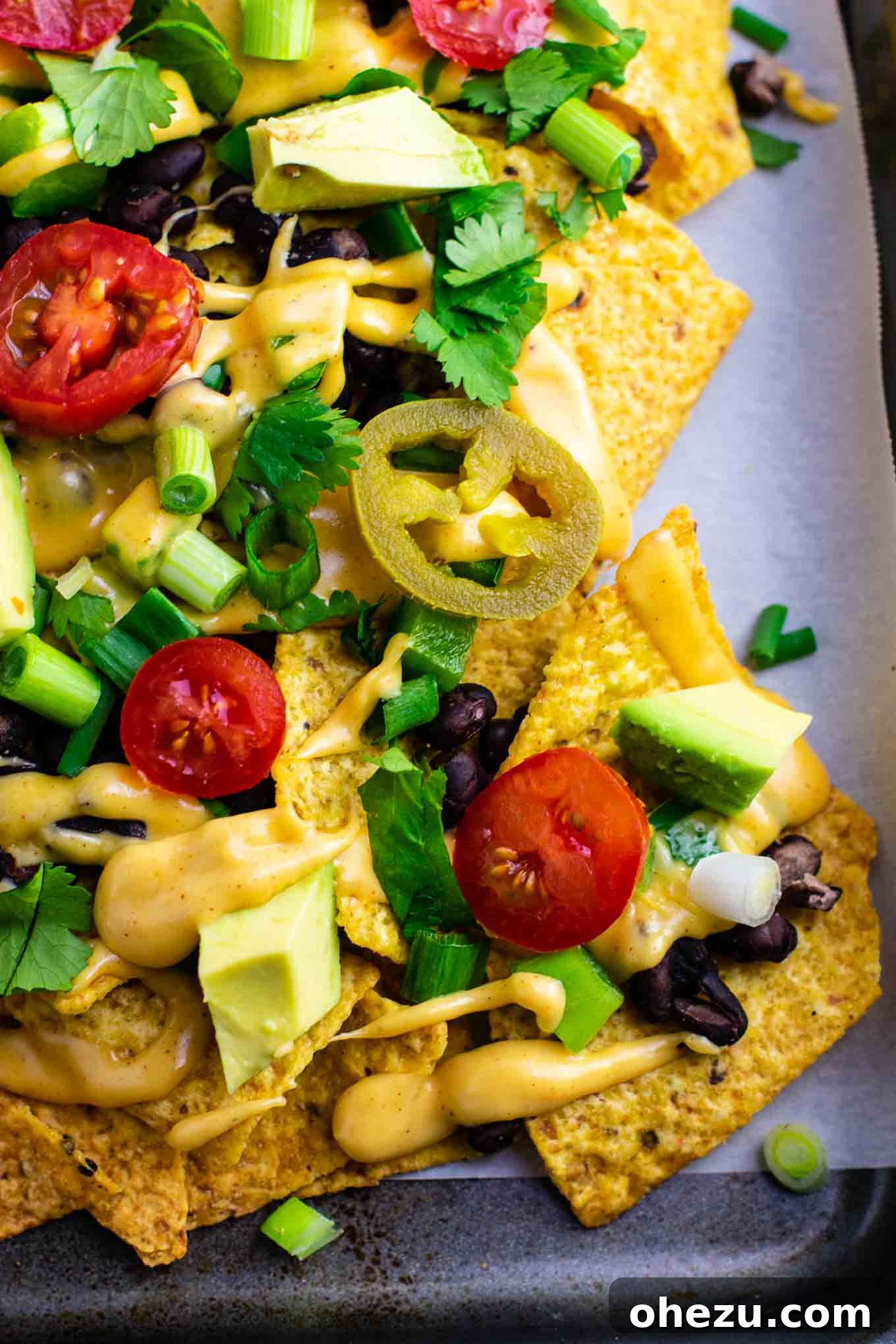 Ultimate Loaded Vegetable Nachos 8 Another enticing angle of the loaded veggie nachos, showing the richness and abundance of toppings. #veggienachos #vegetarian #nachocheese #nachocheesesauce