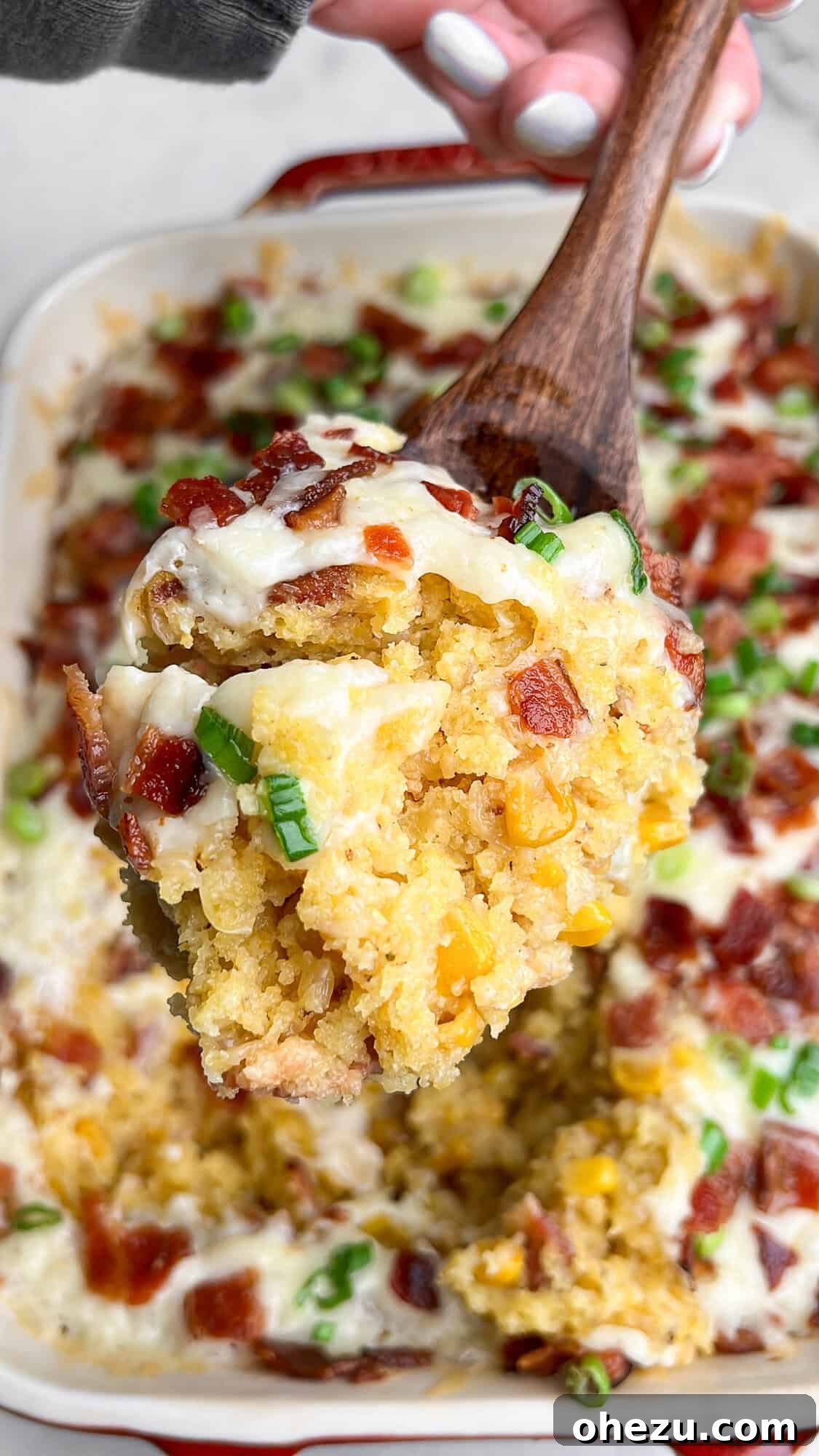 Close-up of the golden-brown, cheesy loaded corn casserole with bacon bits