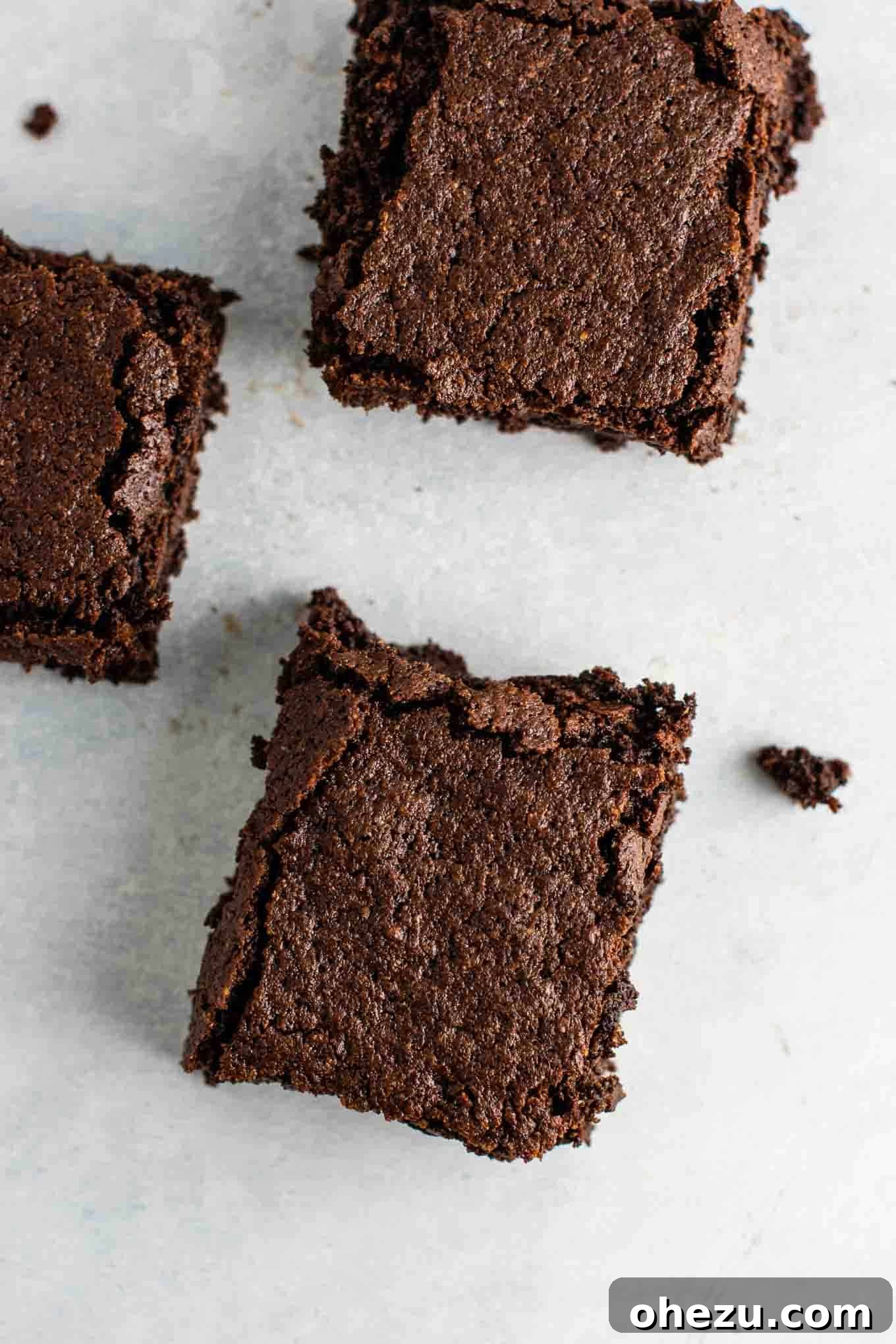 Ultra Fudgy Gluten-Free Brownies 5 Perfectly sliced, rich gluten-free brownies cooling on a wire rack, showcasing their incredible fudgy texture. A dairy-free dessert that everyone will love.