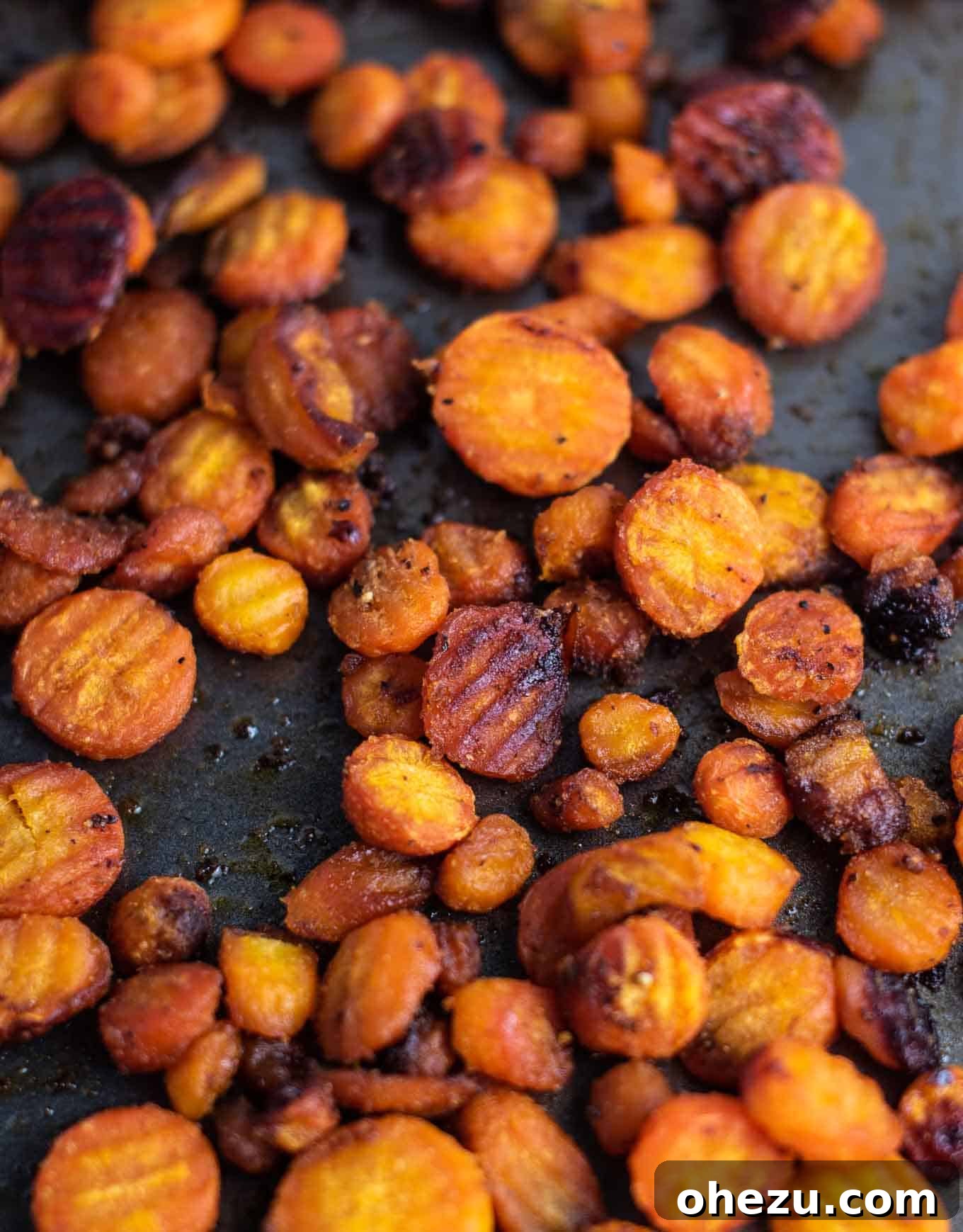 A close-up image showing the perfect texture of finished oven-roasted crinkle-cut carrots, with visible caramelization and a slight sheen.