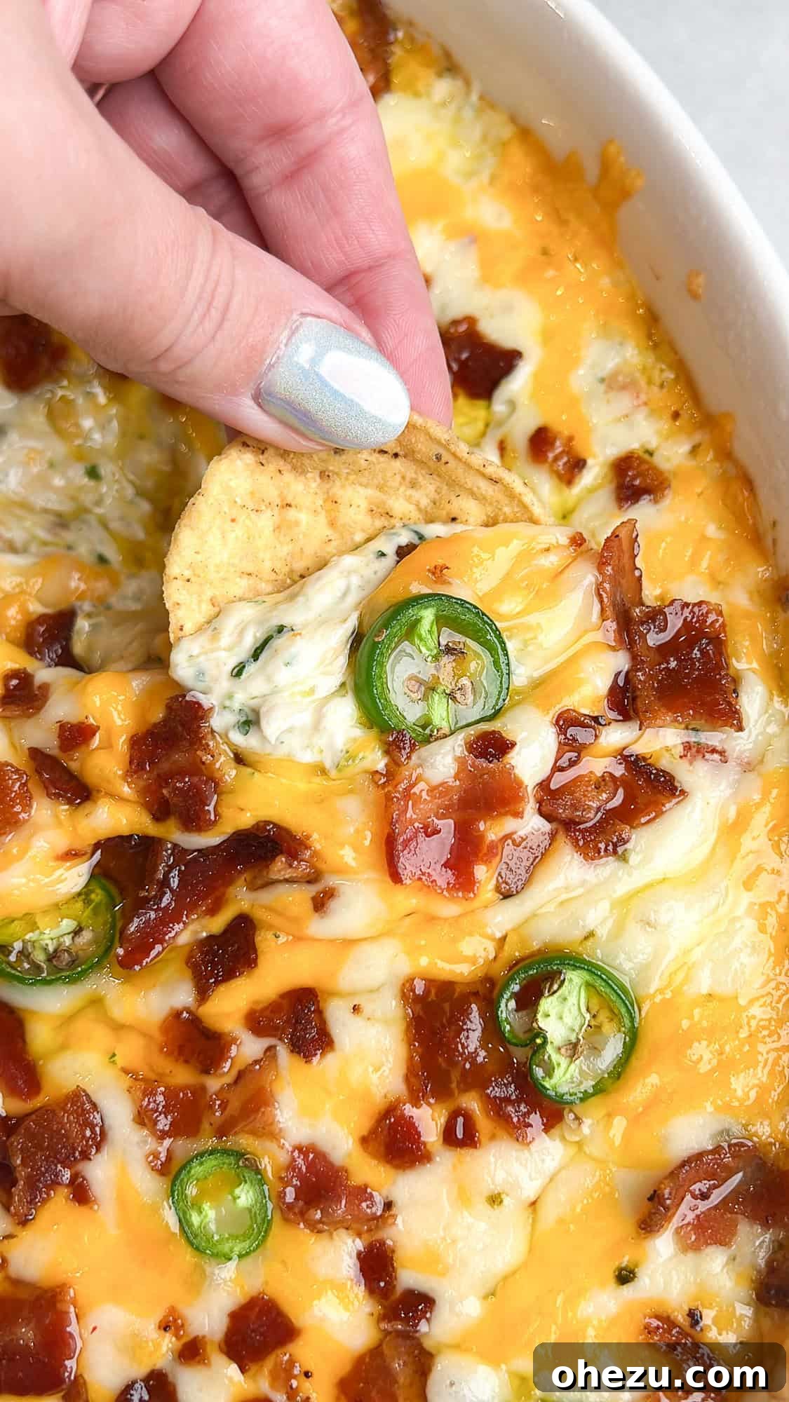 Creamy Baked Tex-Mex Jalapeno Chicken Dip 2 Chuy's-inspired creamy jalapeno chicken dip, served warm in a baking dish
