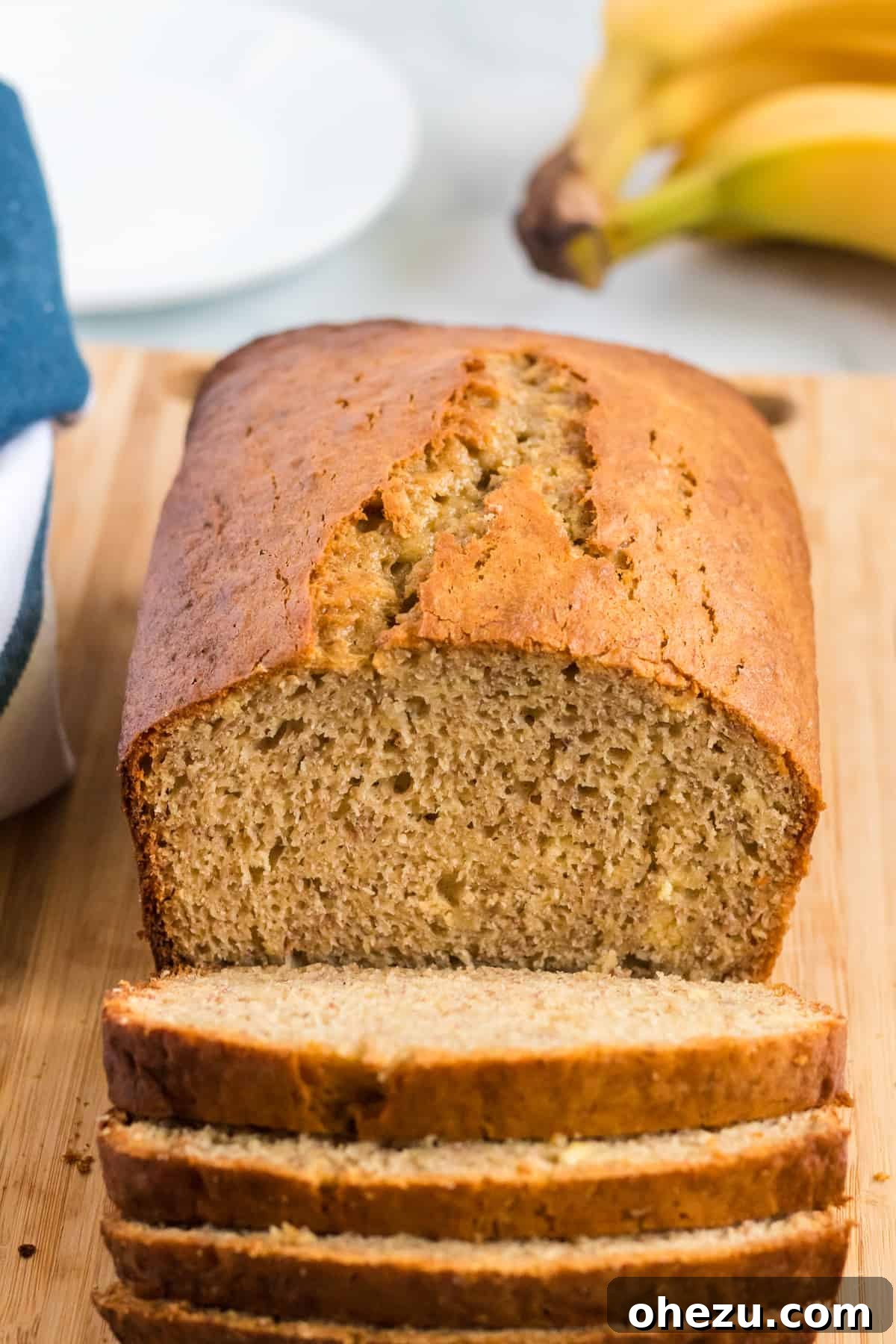 banana bread loaf being cut into slices, showcasing its moist texture