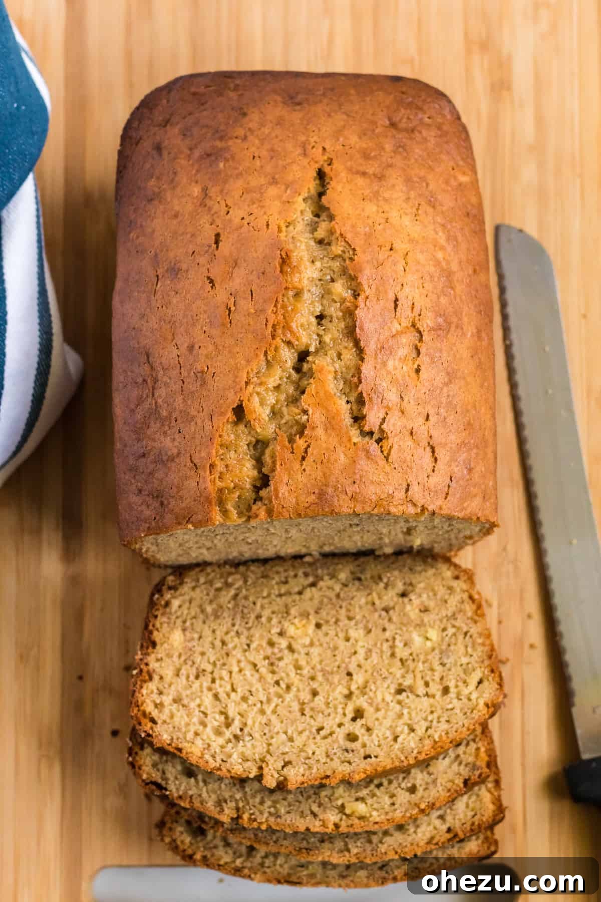 a fresh loaf of banana bread being expertly cut into slices, ready to serve