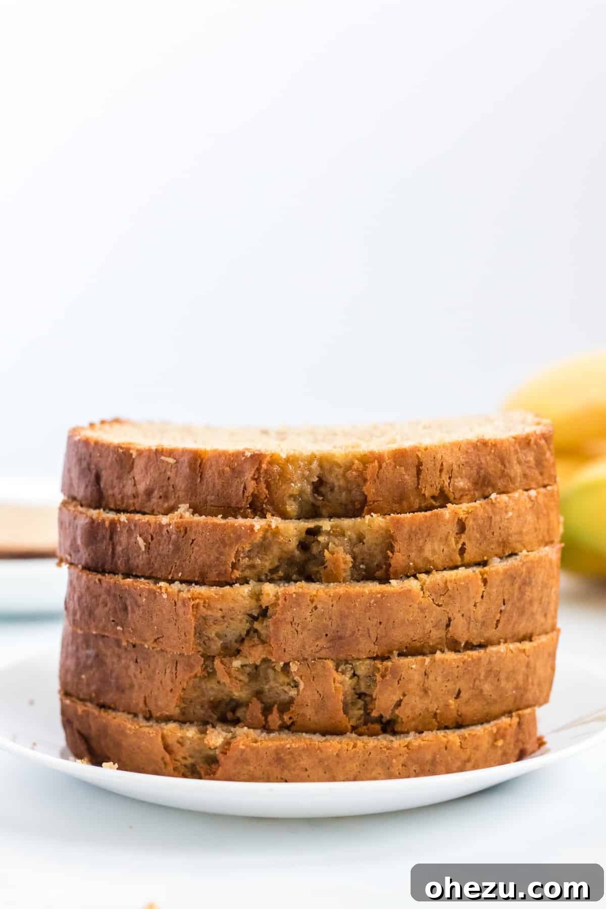 stacked slices of cake mix banana bread on a rustic wooden board, ready to be enjoyed