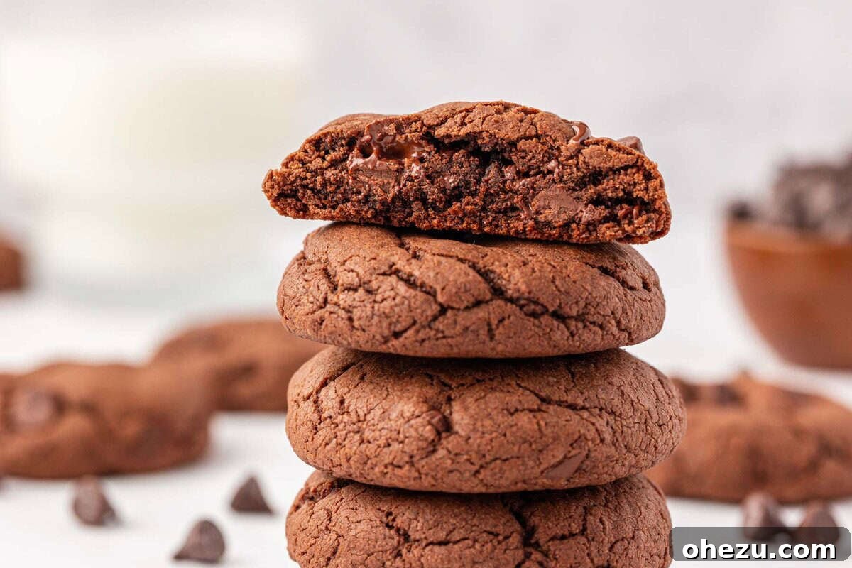 Irresistible Chocolate Cake Mix Cookies 15 Stack of freshly baked chocolate cake mix cookies on a rustic wooden surface