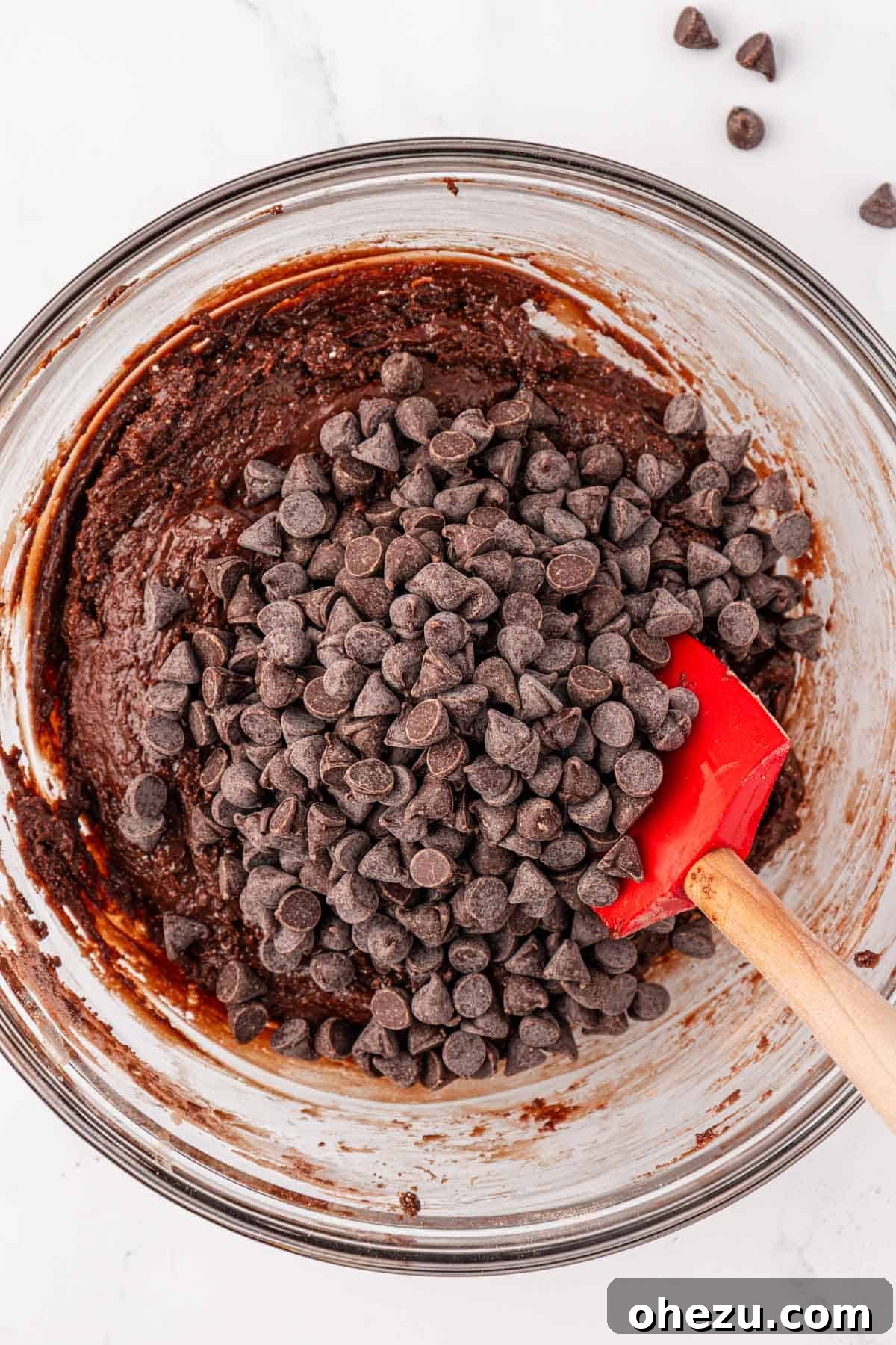 Irresistible Chocolate Cake Mix Cookies 7 Chocolate chips being added to the mixed cake mix cookie batter