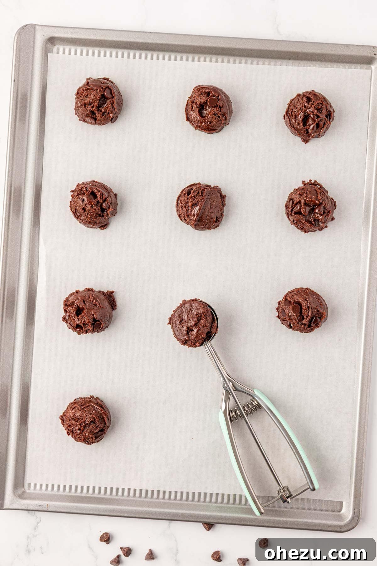 Irresistible Chocolate Cake Mix Cookies 9 Using a mini cookie scoop to portion out chocolate cookie dough onto a baking sheet