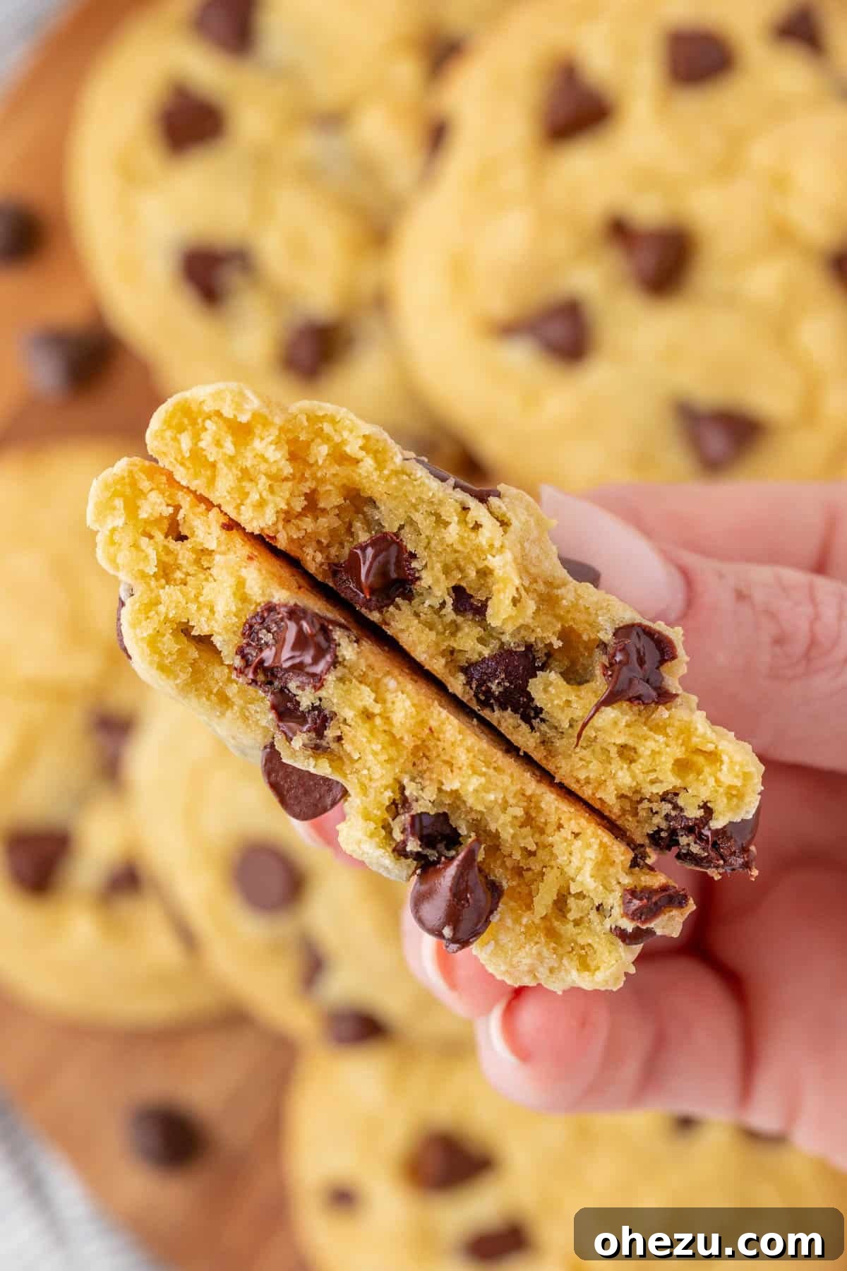 A stack of golden brown cake mix chocolate chip cookies on a wooden board