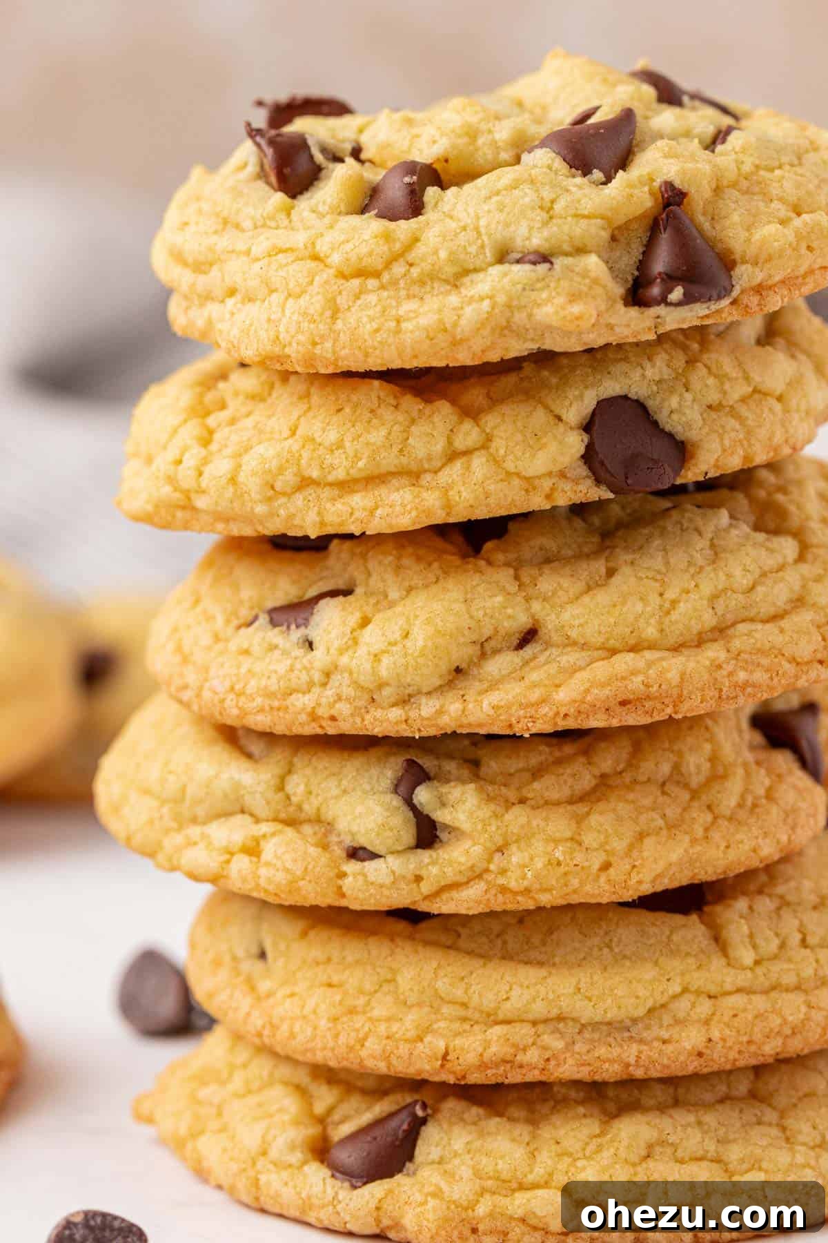 A tall stack of cake mix chocolate chip cookies on a white surface