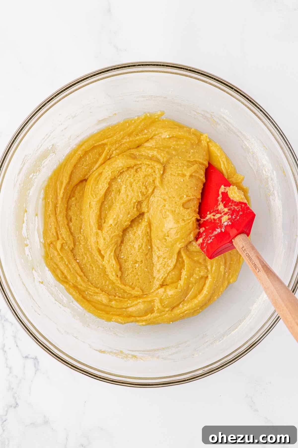 Cake mix cookie batter mixed together, showing a thick and gooey consistency