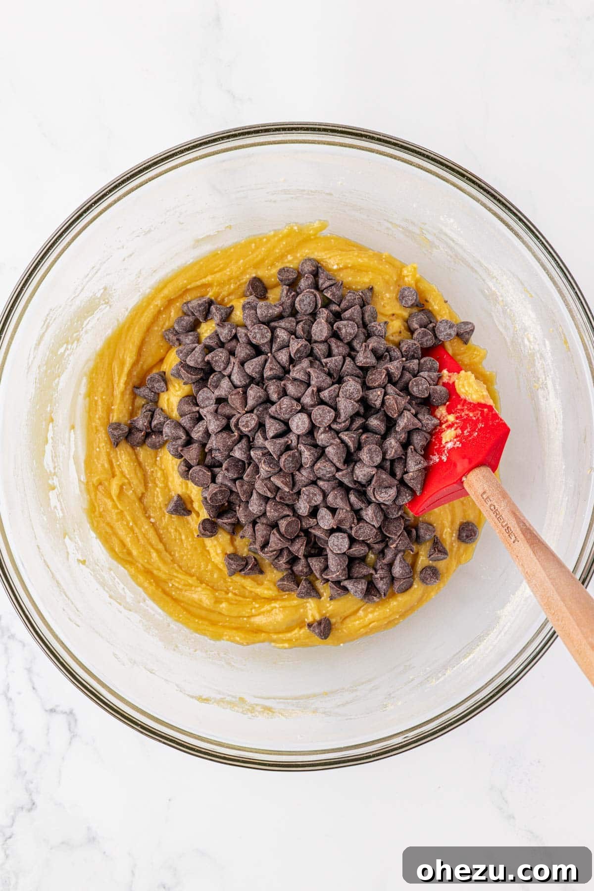 Adding semi-sweet chocolate chips to the thick cake mix cookie batter