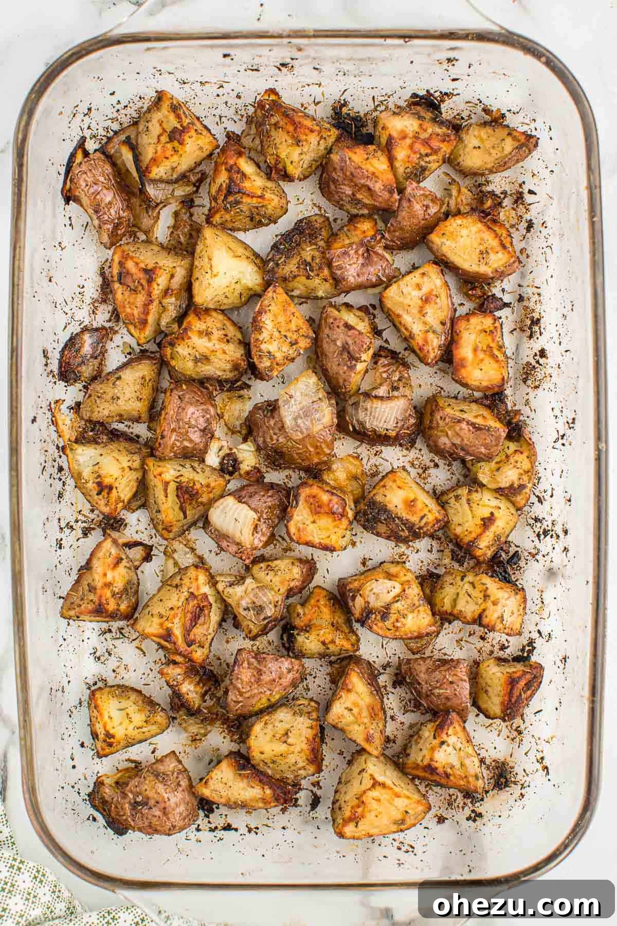 Roasted potatoes and onions in a baking dish after cooking