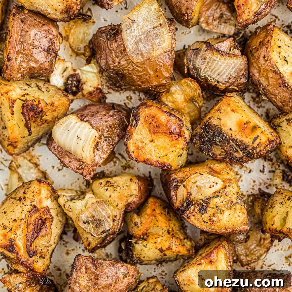 Easy roasted potatoes with onions on a white plate