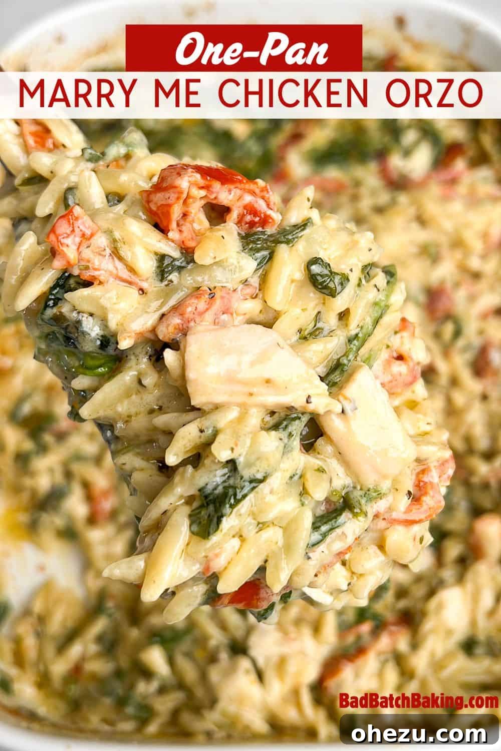 Skillet Chicken Orzo That Wins Hearts 12 A delicious spoonful of Marry Me Chicken Orzo with spinach and tomatoes, held over the full pan, perfect for Pinterest.