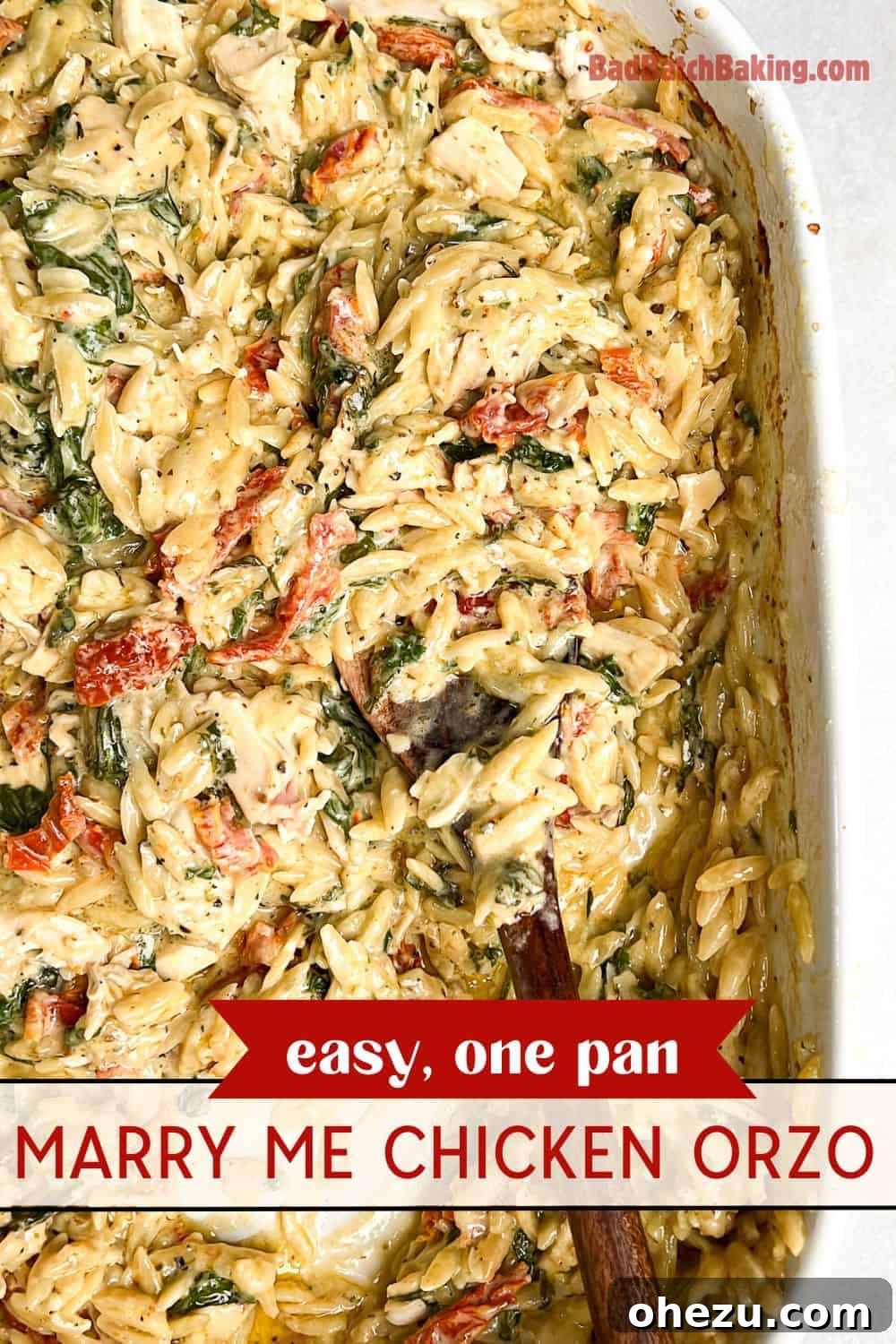 Skillet Chicken Orzo That Wins Hearts 14 Creamy chicken orzo in a large baking pan with a serving spoon, highlighting the ease of this one-pan dish.