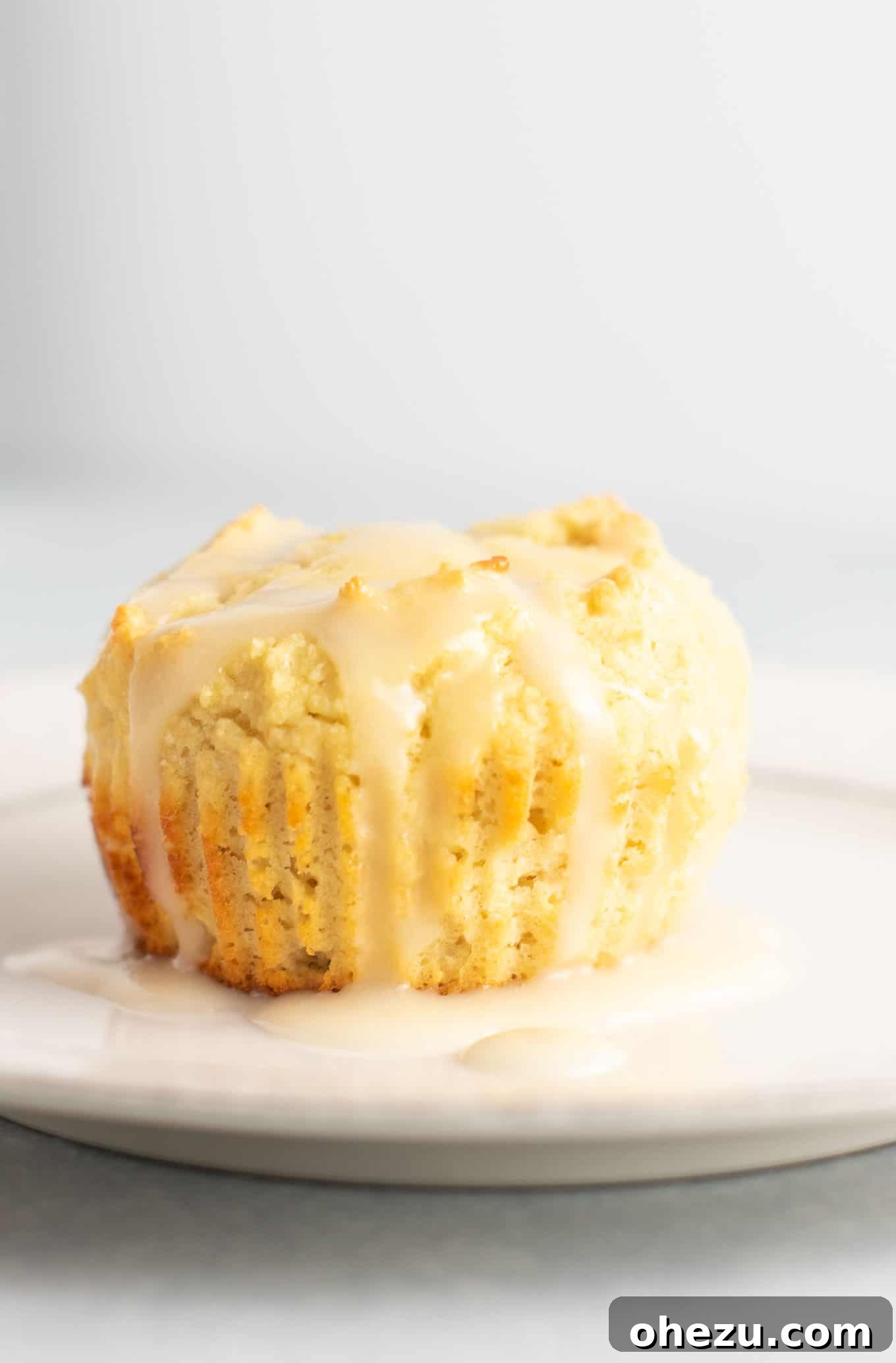An array of delicious gluten-free lemon muffins, beautifully arranged and topped with a glistening lemon glaze, ready to be enjoyed.