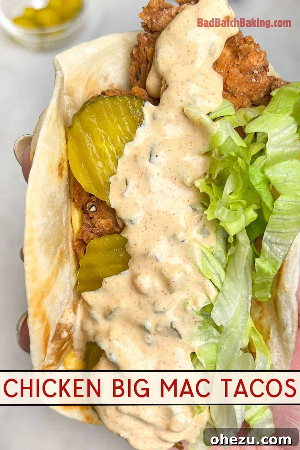 Ultimate Chicken Big Mac Taco 15 A close-up of a perfectly fried chicken taco, garnished with Big Mac sauce, crisp lettuce, and tangy pickles.