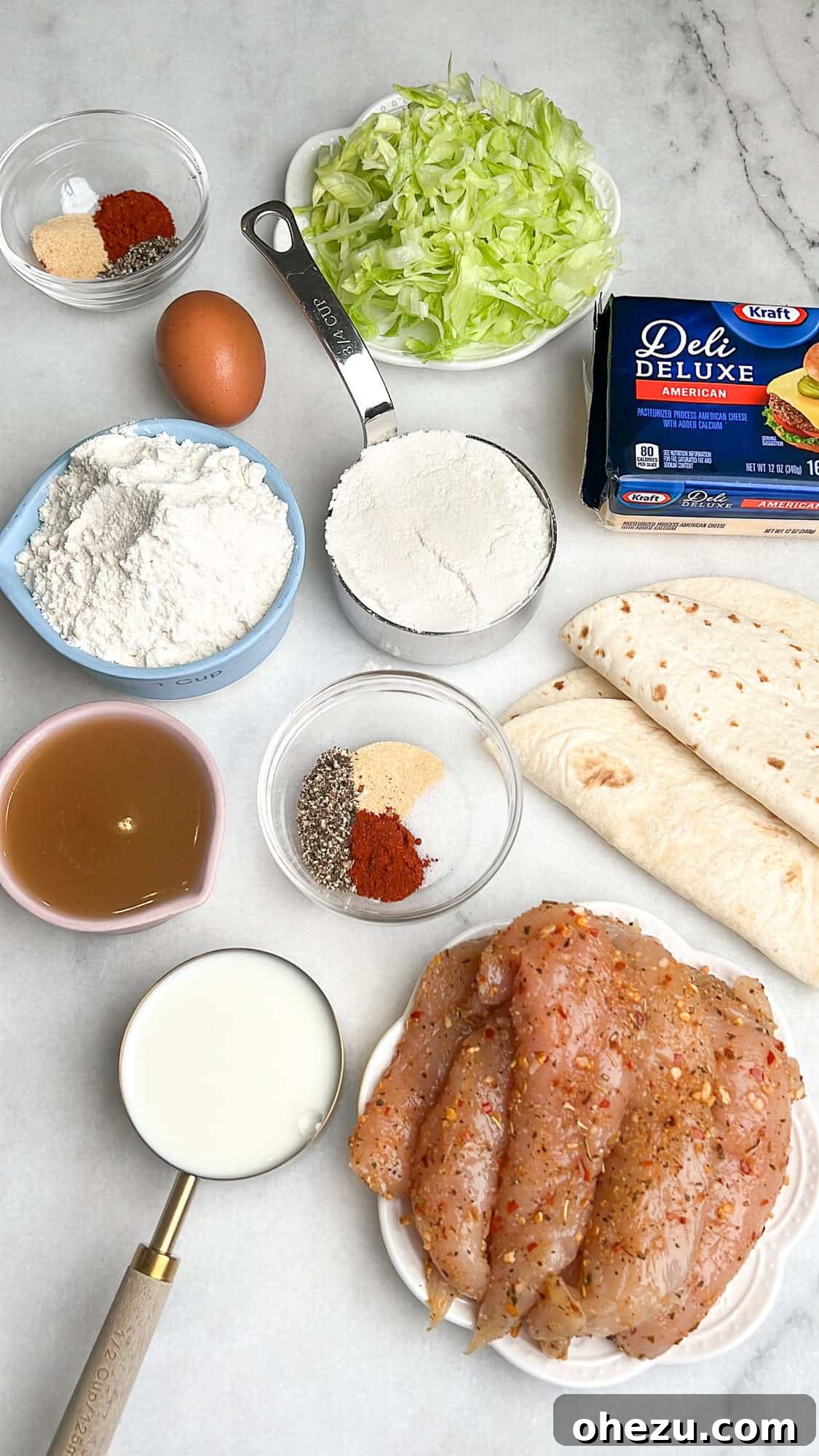 Ultimate Chicken Big Mac Taco 4 All the fresh ingredients for homemade chicken Big Mac tacos laid out on a kitchen counter, showcasing vibrant lettuce, pickles, cheese, chicken, and sauce components.