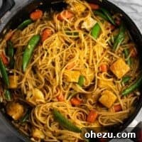 Tofu stir fry noodles in a skillet, showcasing a delicious and healthy gluten-free vegetarian meal.