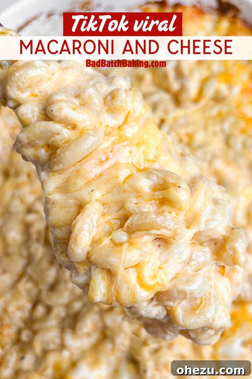 Another perspective of baked macaroni and cheese being served, showing the layers of cheese.