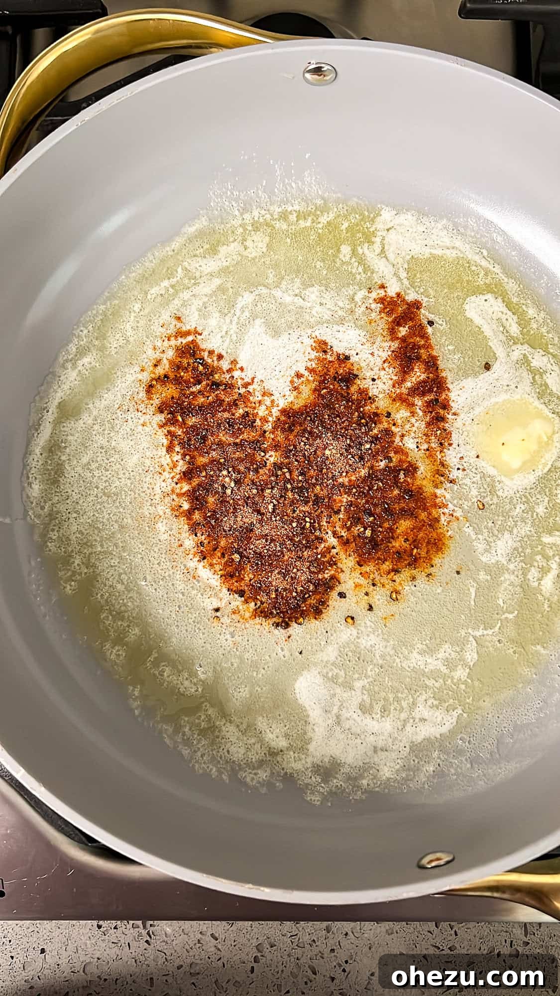 Step 1: Melted butter and seasonings mixing in a skillet.