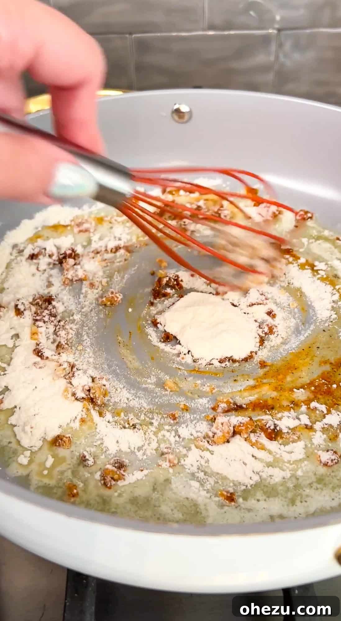 Step 2: Flour being added to the butter and seasoning mixture to create a roux.