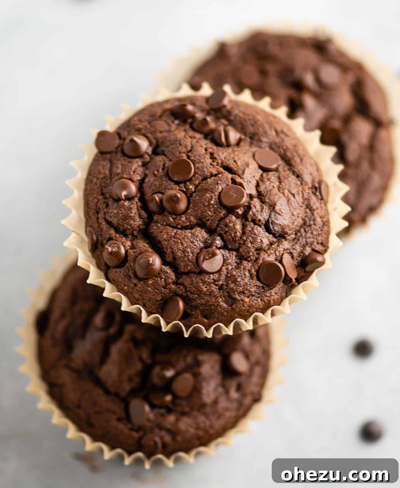 Unbelievably Delicious Gluten Free Chocolate Muffins 7 One gluten-free chocolate muffin stacked atop two others, showcasing their delightful texture