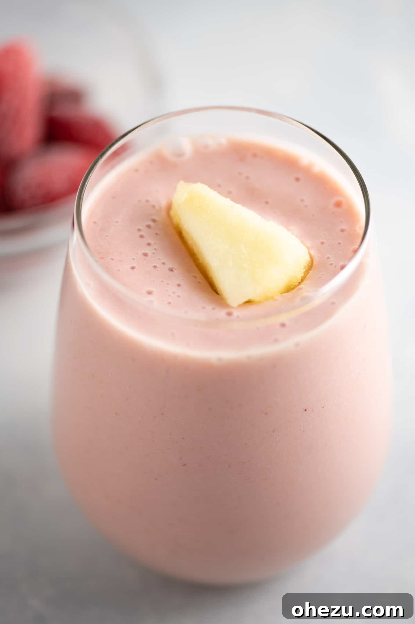 Strawberry Pineapple Paradise 4 Creamy strawberry pineapple smoothie topped with fresh mint and a piece of frozen pineapple