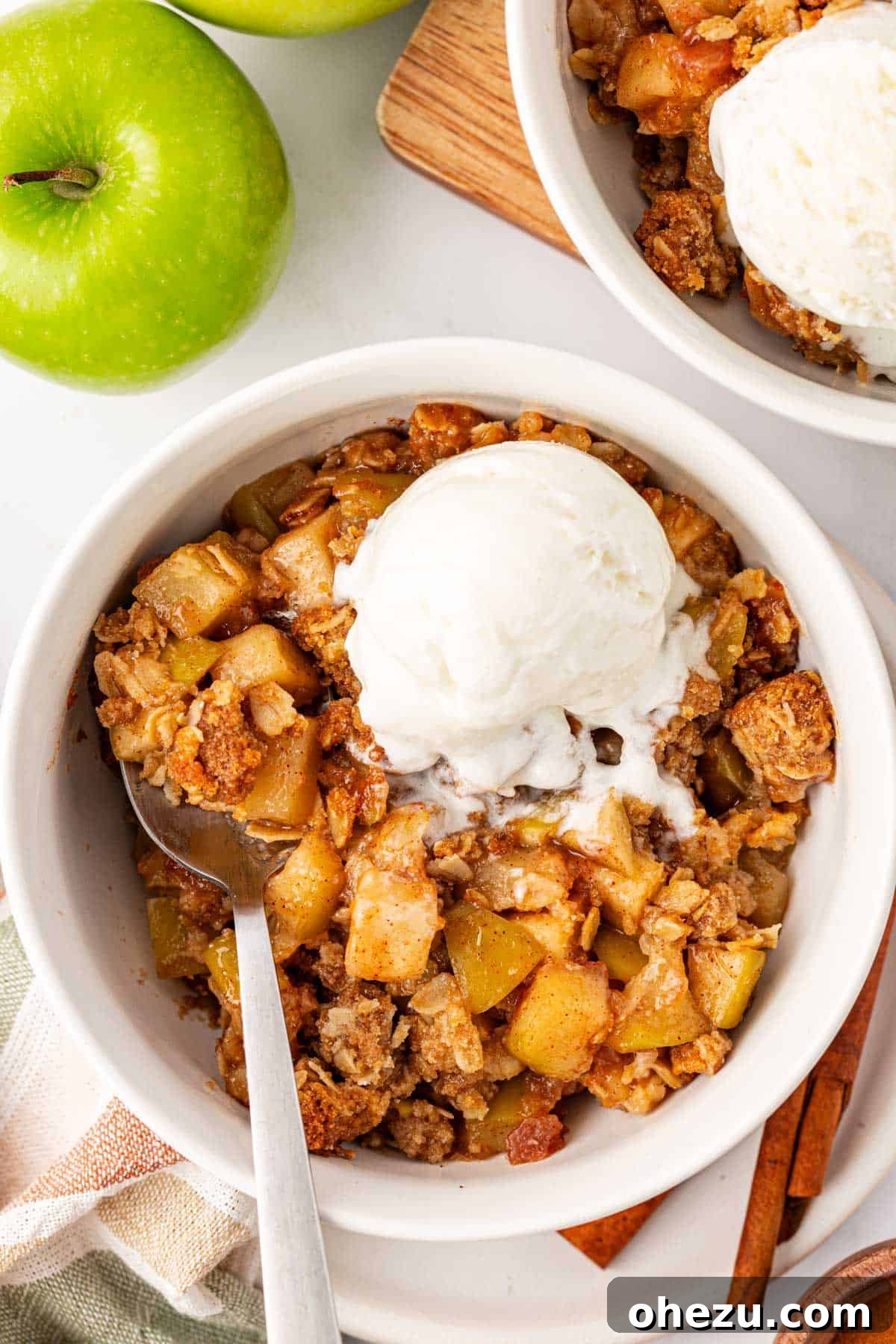 Heavenly Gluten-Free Apple Crumble 2 Gluten-free apple crisp topped with a scoop of melting vanilla ice cream, showcasing its golden-brown, crispy topping and bubbly apple filling.