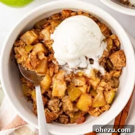 gluten free apple crisp topped with a scoop of vanilla ice cream