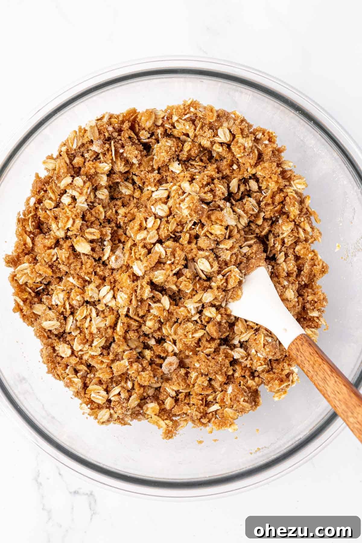 Heavenly Gluten-Free Apple Crumble 10 The gluten-free apple crisp topping after mixing, showing a crumbly, wet sand-like texture in a bowl.