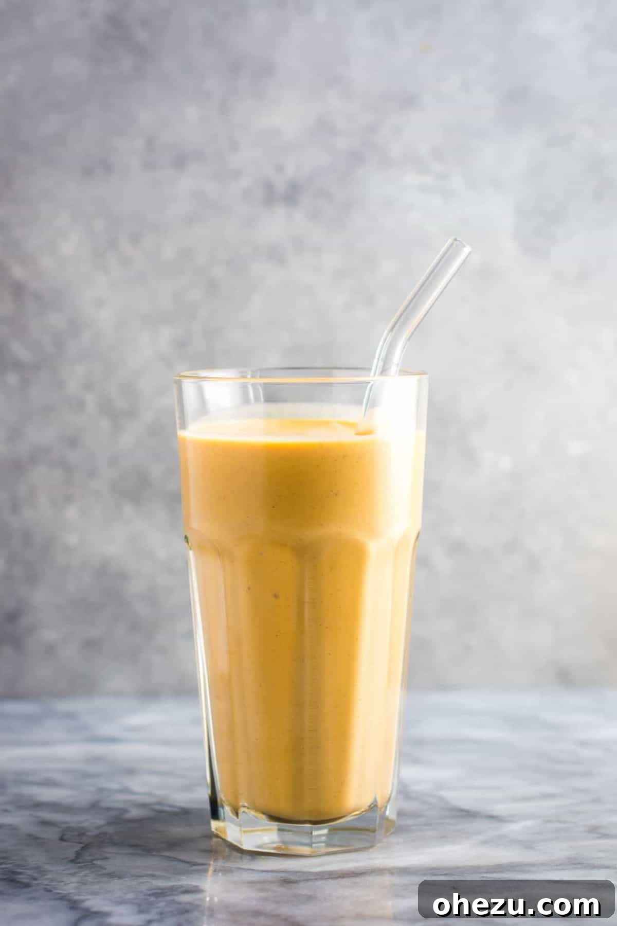 Mastering Homemade Smoothies 11 a sweet potato smoothie in a glass with a glass straw, showcasing its thick and inviting texture